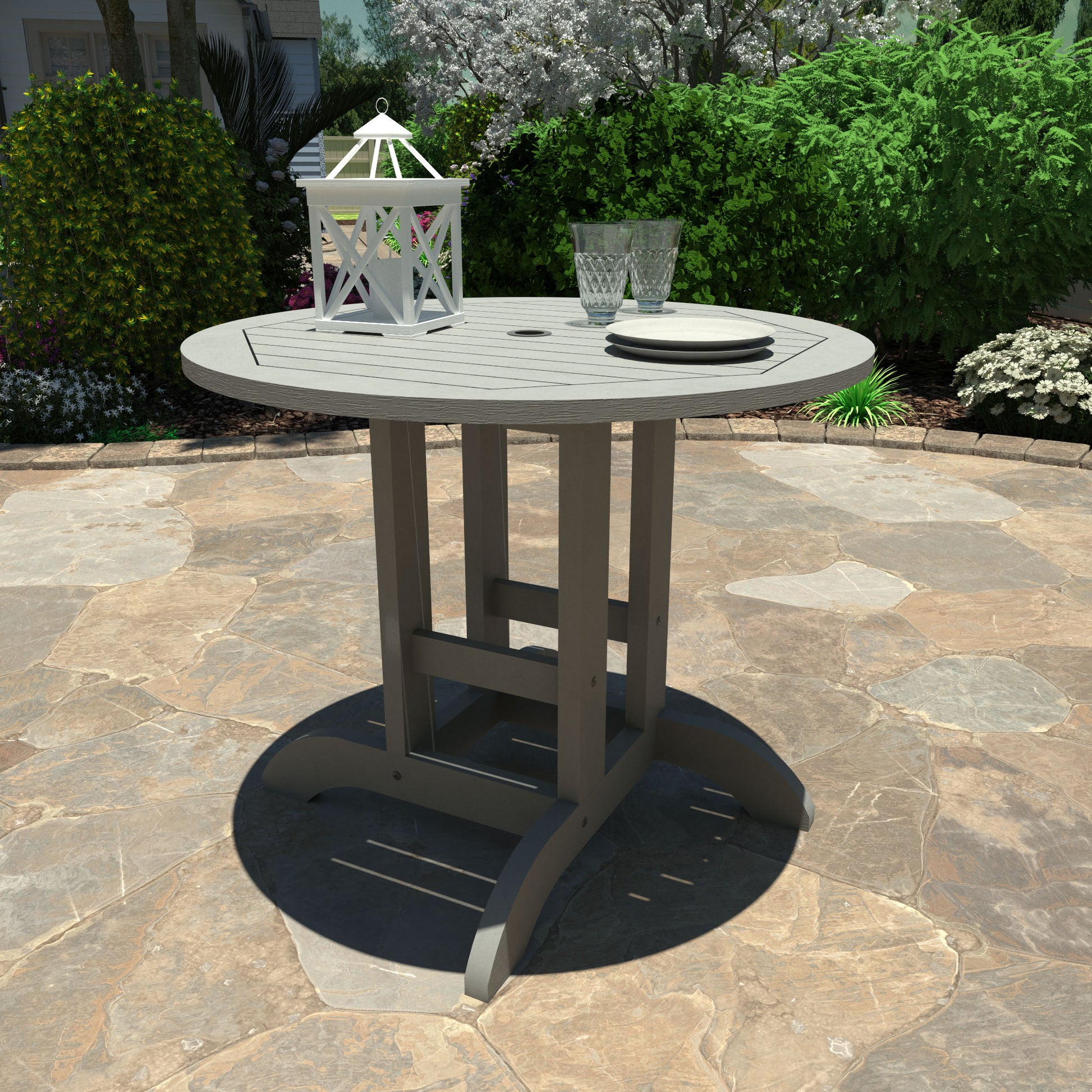 Gray 36” diameter dining height table with lantern, plates, and glasses