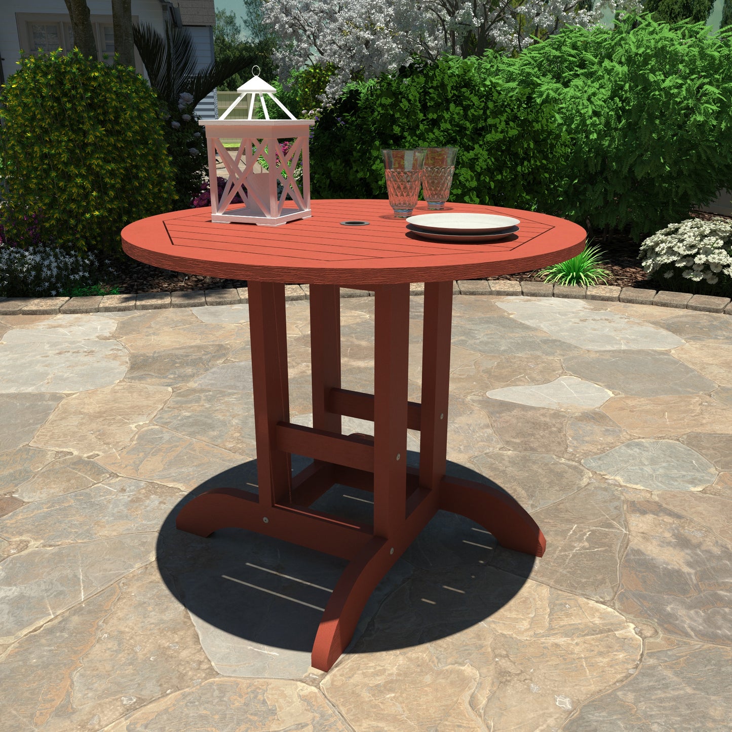 Red 36” diameter dining height table with lantern, plates, and glasses