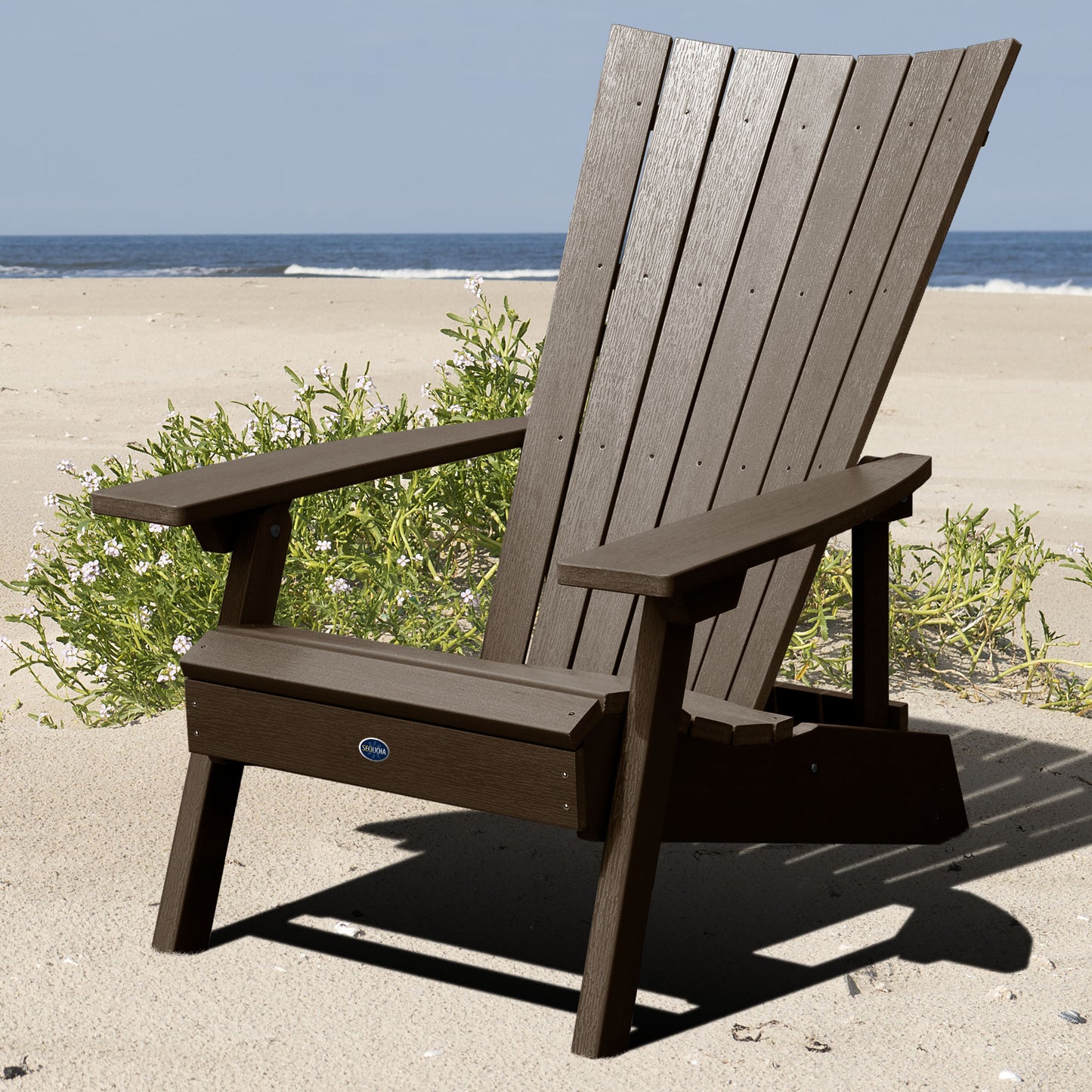 Brown Granite Hills folding and reclining Adirondack chair on a beach