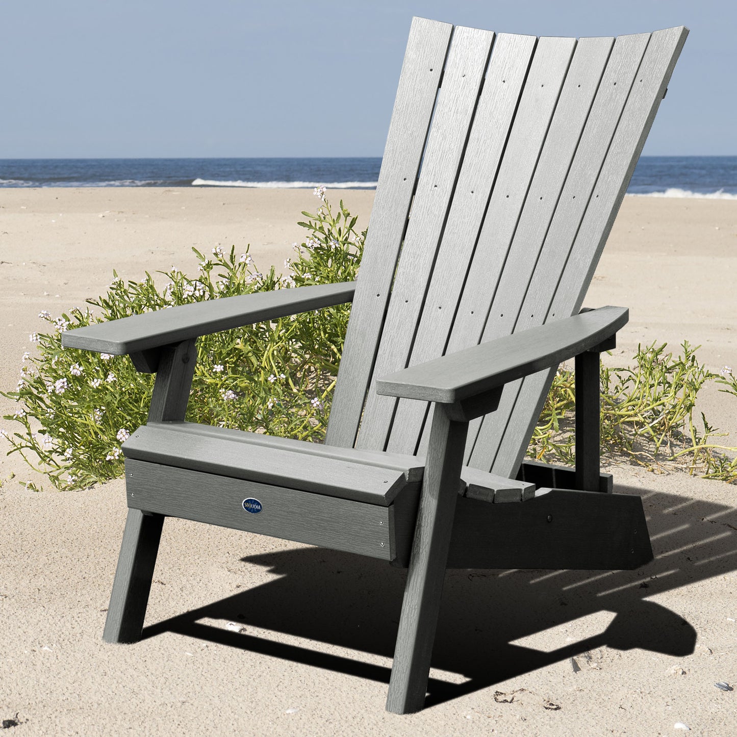 Gray Granite Hills folding and reclining Adirondack chair on a beach