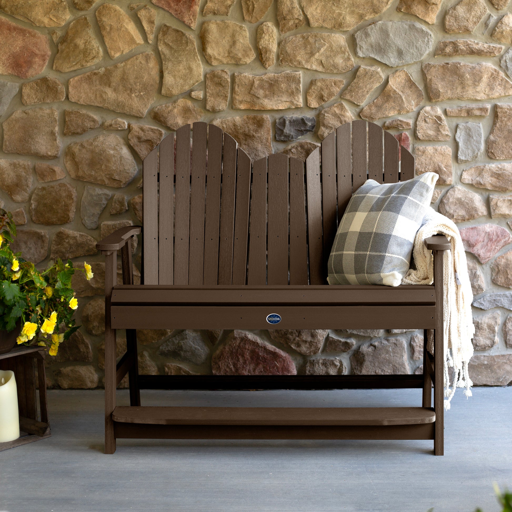 Brown Lighthouse counter height Adirondack bench against stone wall