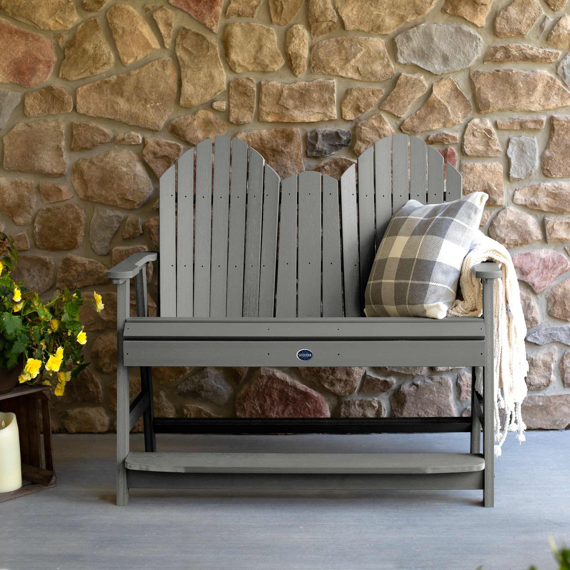 Gray Lighthouse counter height Adirondack bench against stone wall
