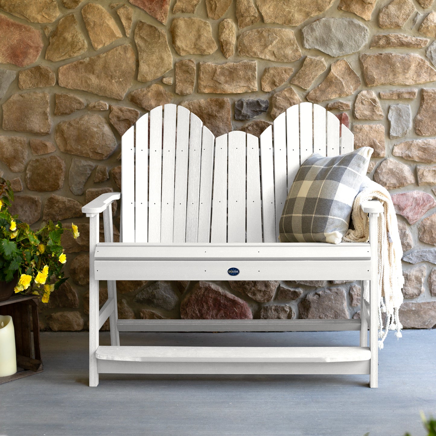 White Lighthouse counter height Adirondack bench against stone wall