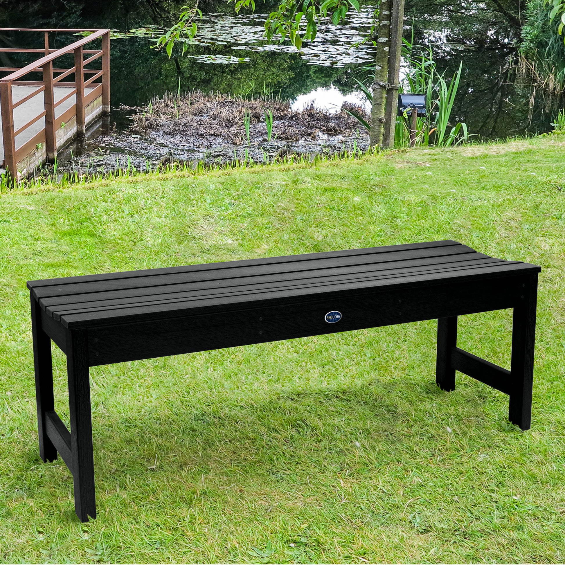 4ft black Blue Ridge backless bench on grassy lawn