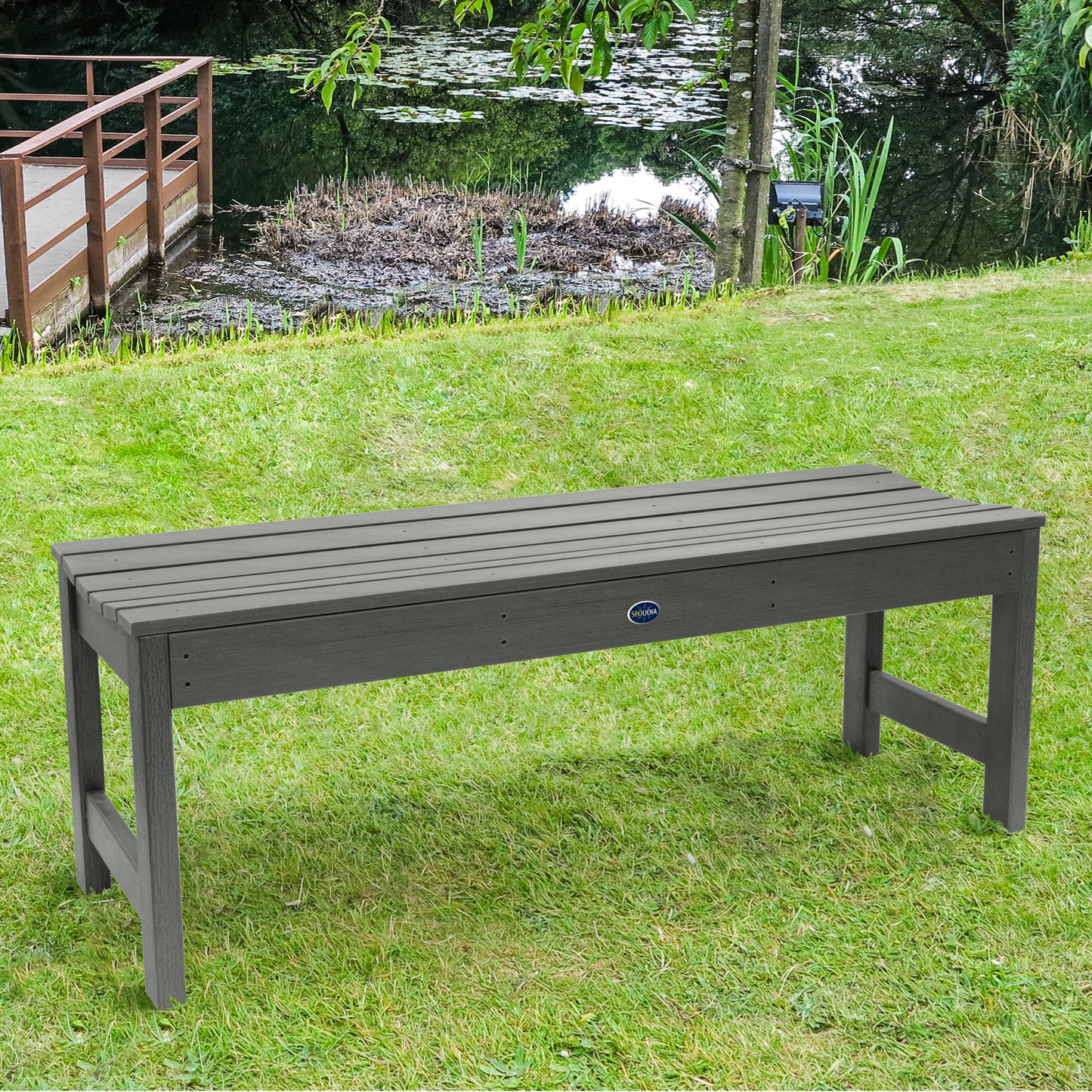 4ft light gray Blue Ridge backless bench on grassy lawn