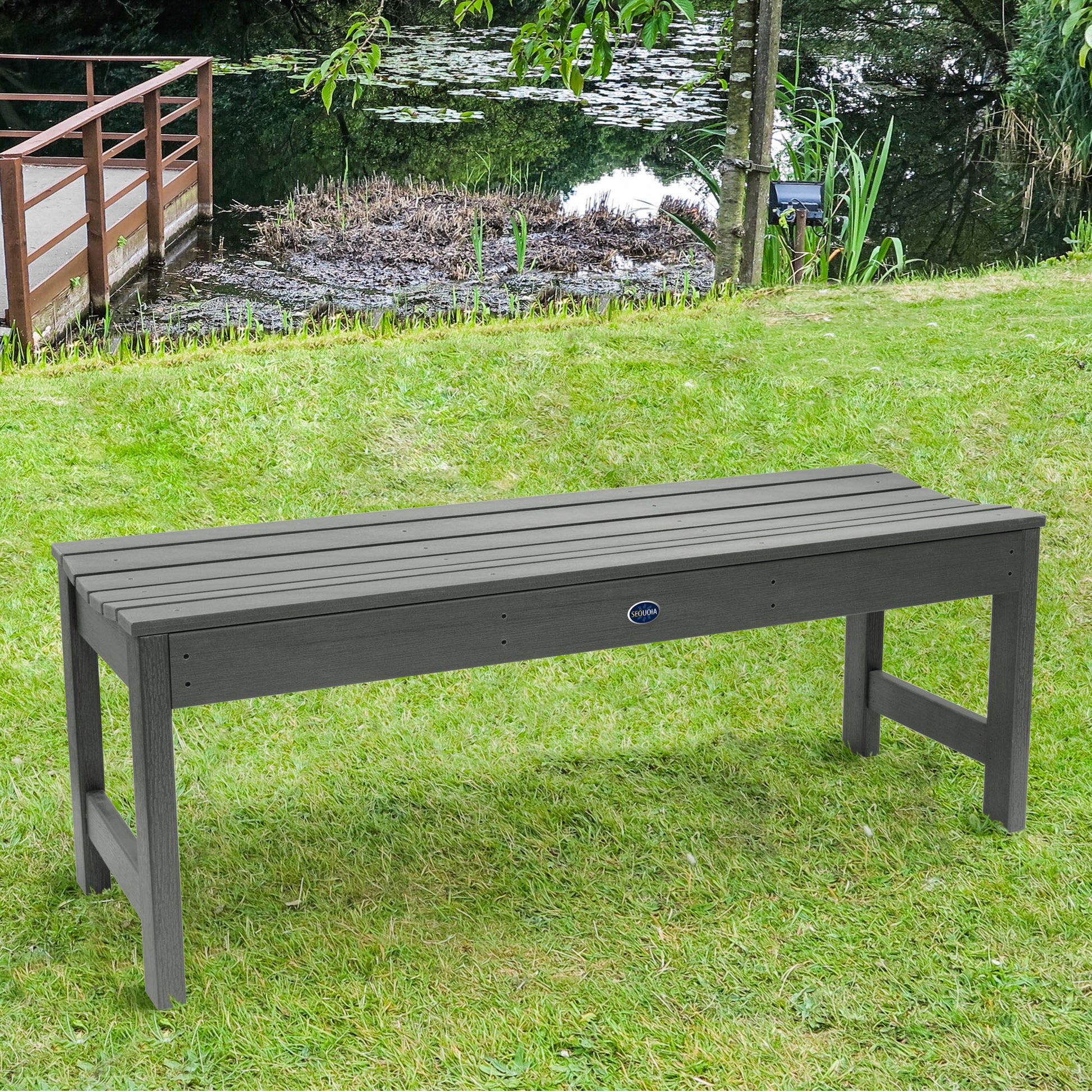 4ft light gray Blue Ridge backless bench on grassy lawn