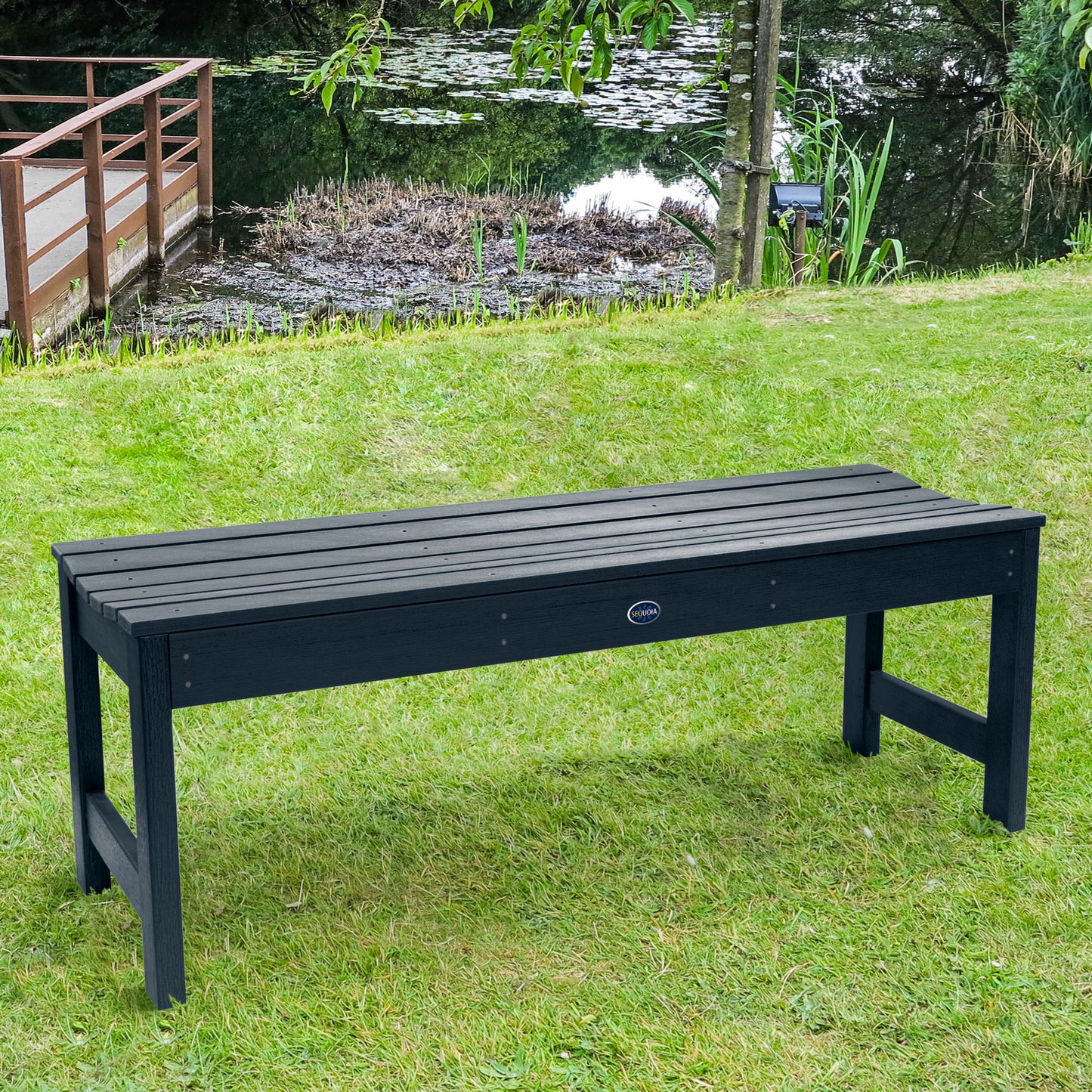 4ft dark blue Blue Ridge backless bench on grassy lawn