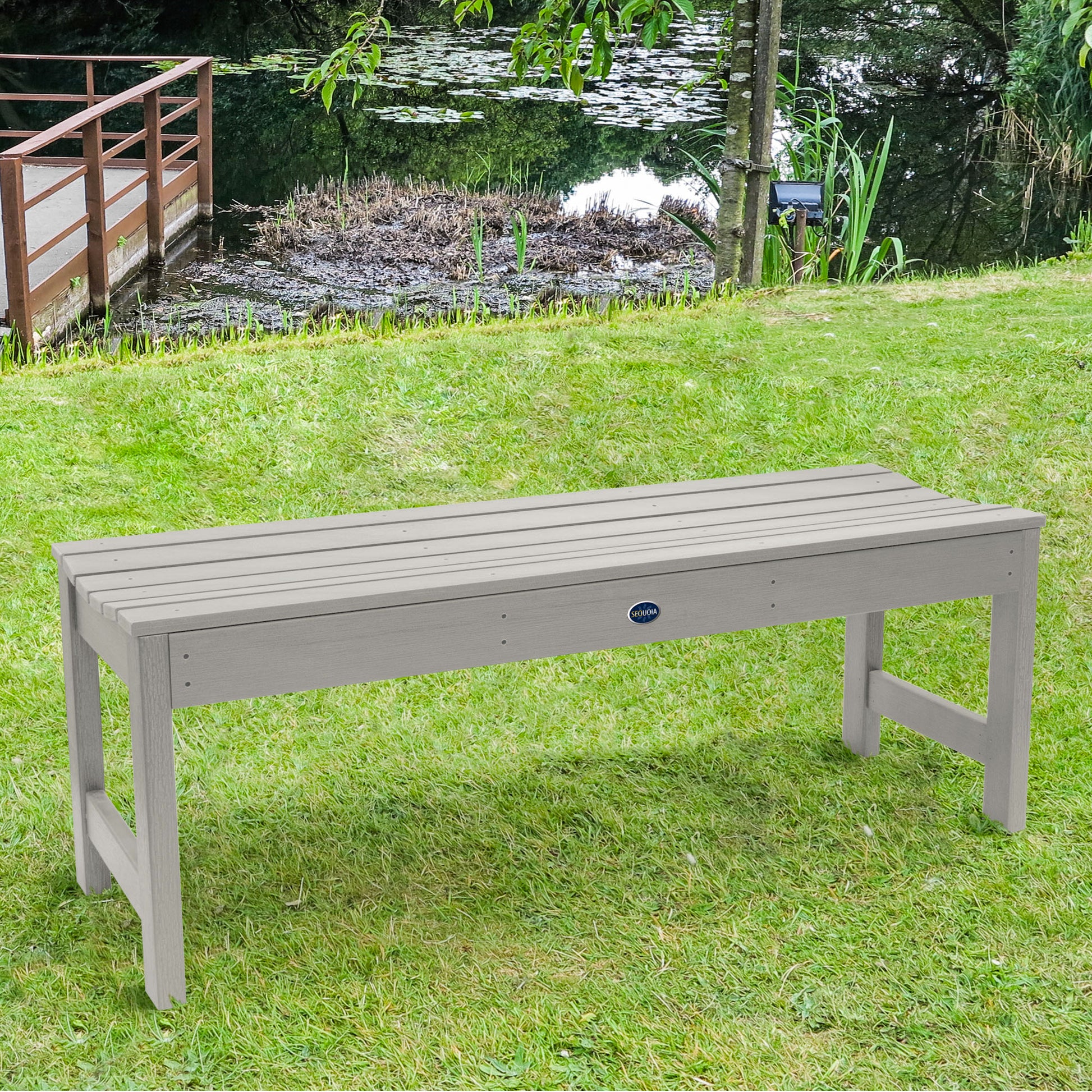 4ft light gray Blue Ridge backless bench on grassy lawn