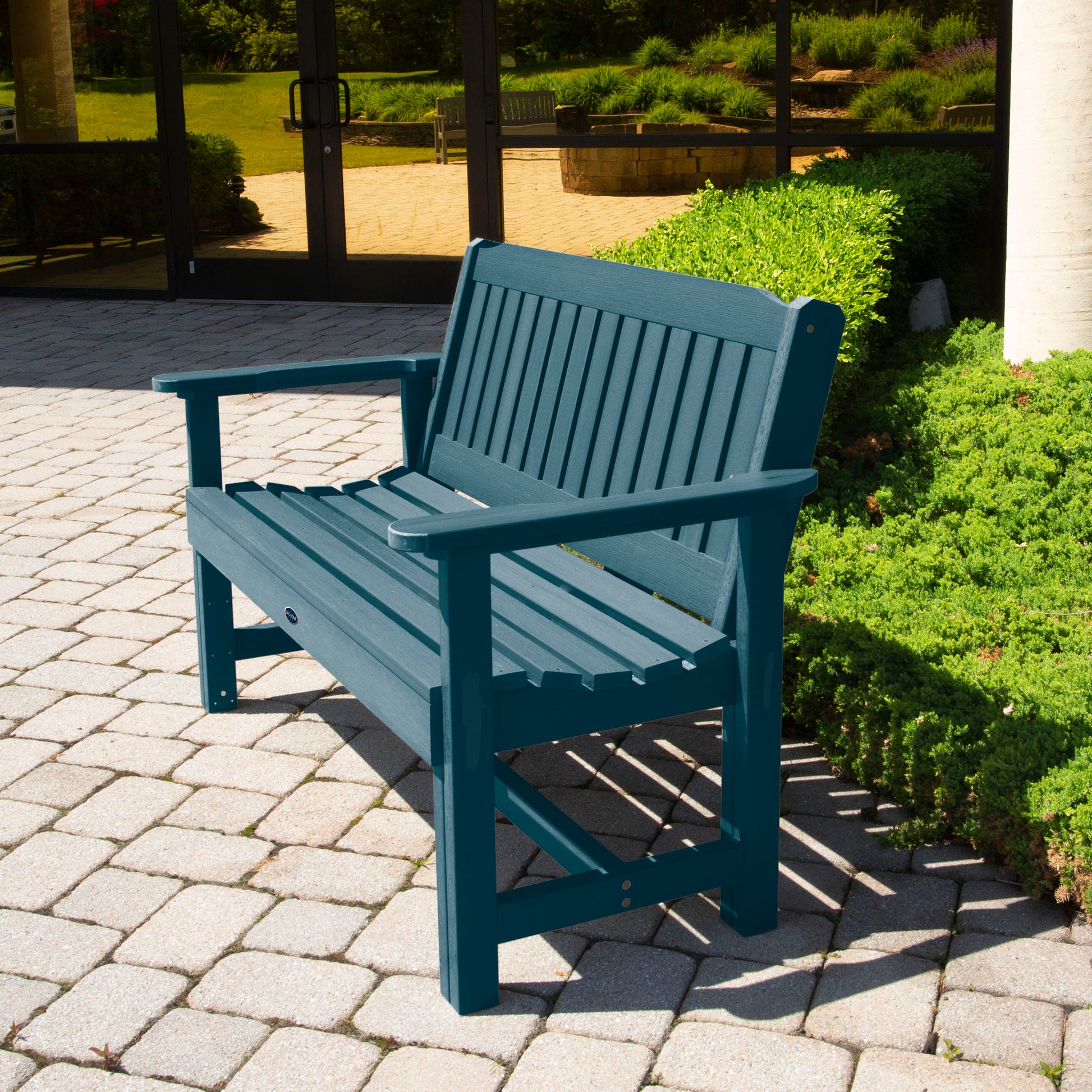 Light blue 4ft Blue Ridge Commercial Garden Bench on stone pathway