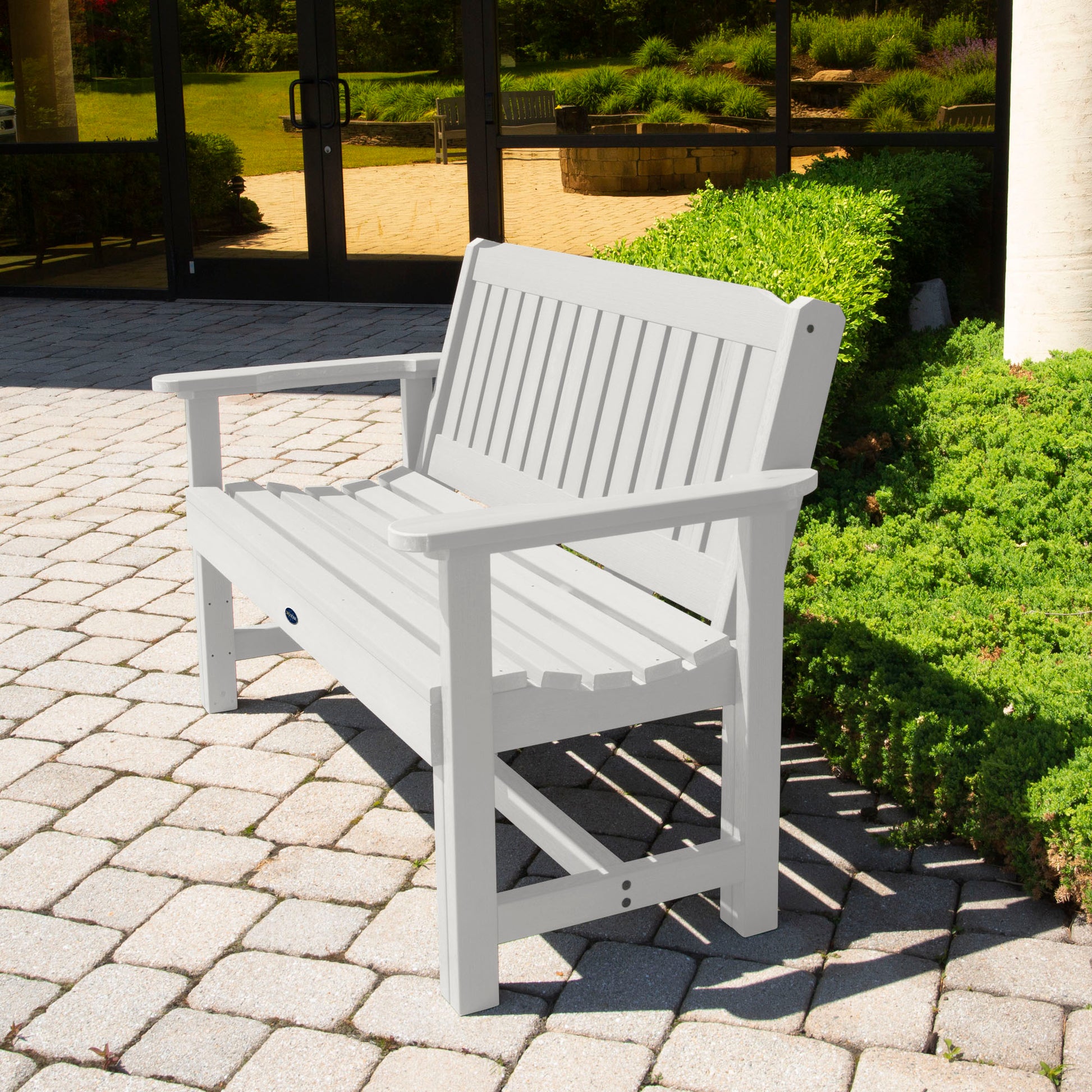 White 4ft Blue Ridge Commercial Garden Bench on stone pathway