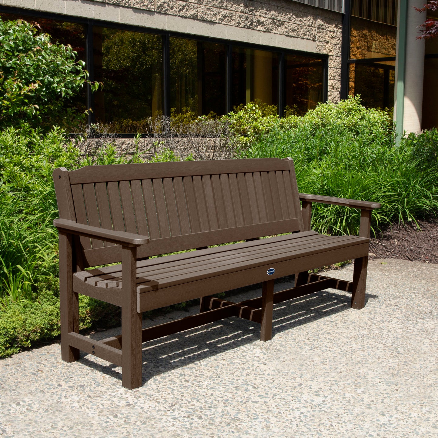 Brown 6ft Blue Ridge Garden Bench with bushes in background