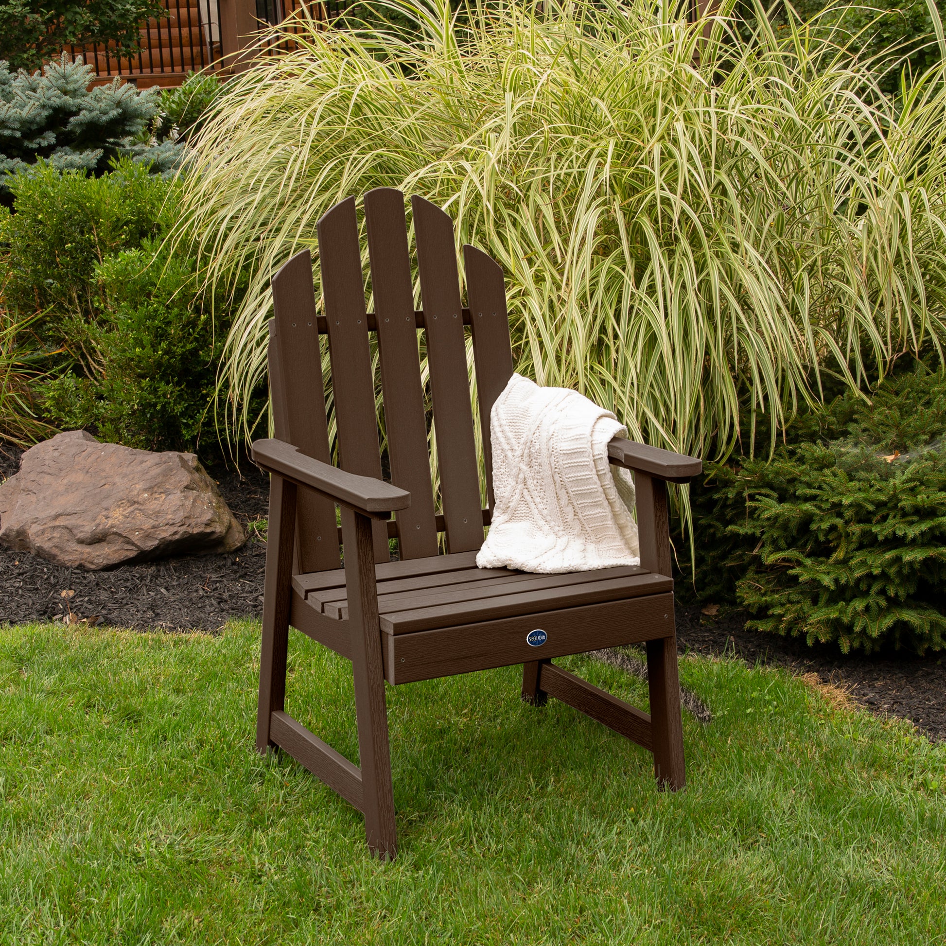 Brown Lighthouse Garden Chair on grass in front of bushes
