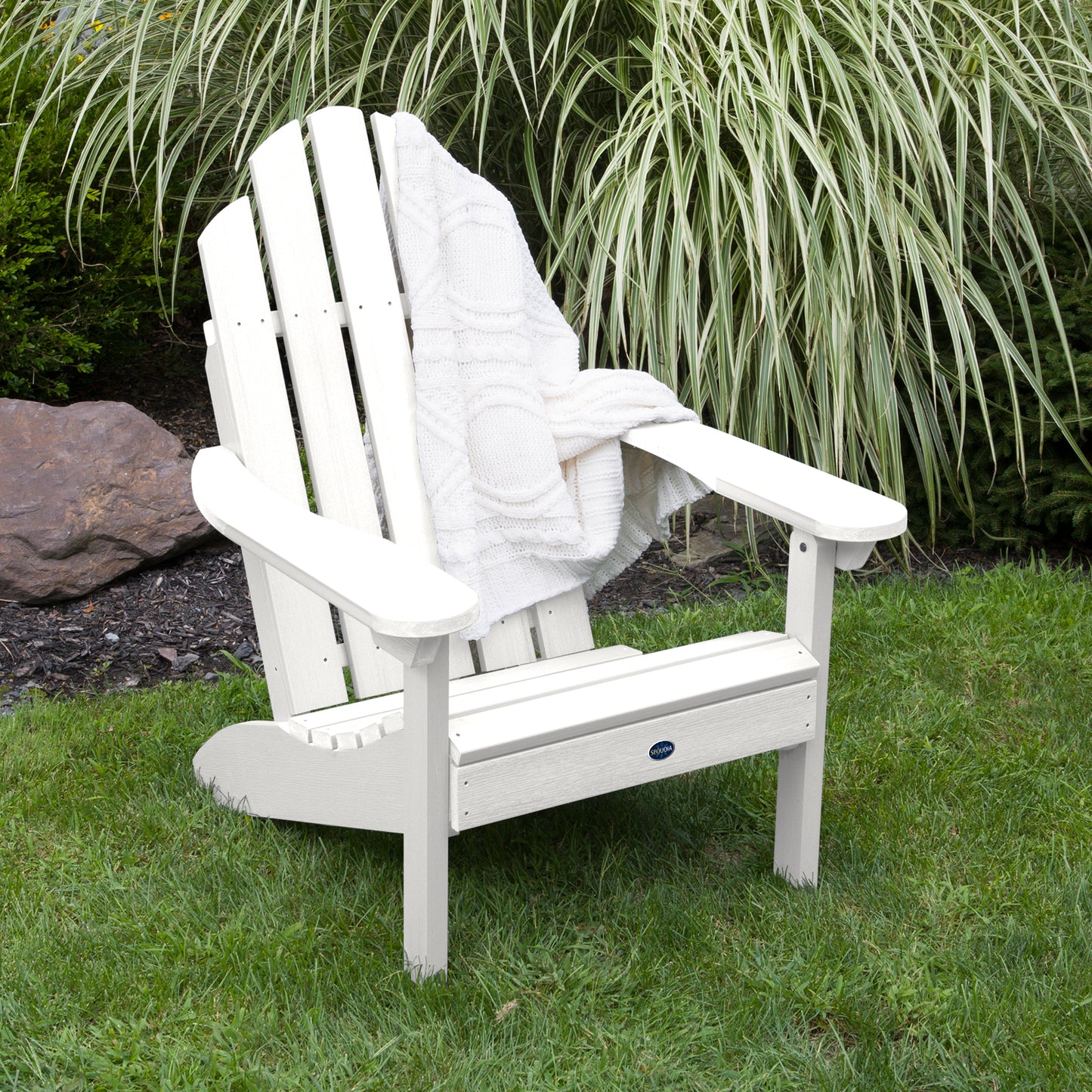 White Lighthouse Classic Adirondack Chair with blanket on grass
