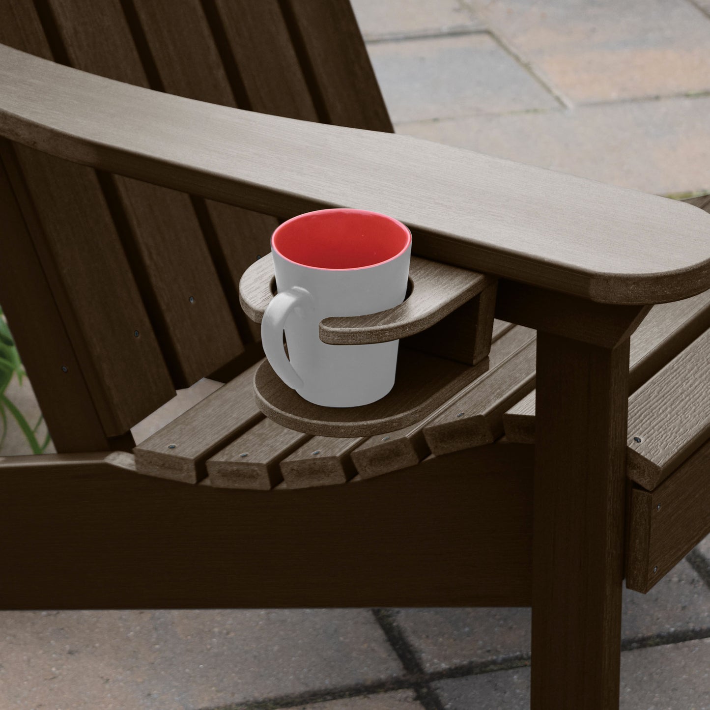 Brown Adirondack chair and cupholder with mug