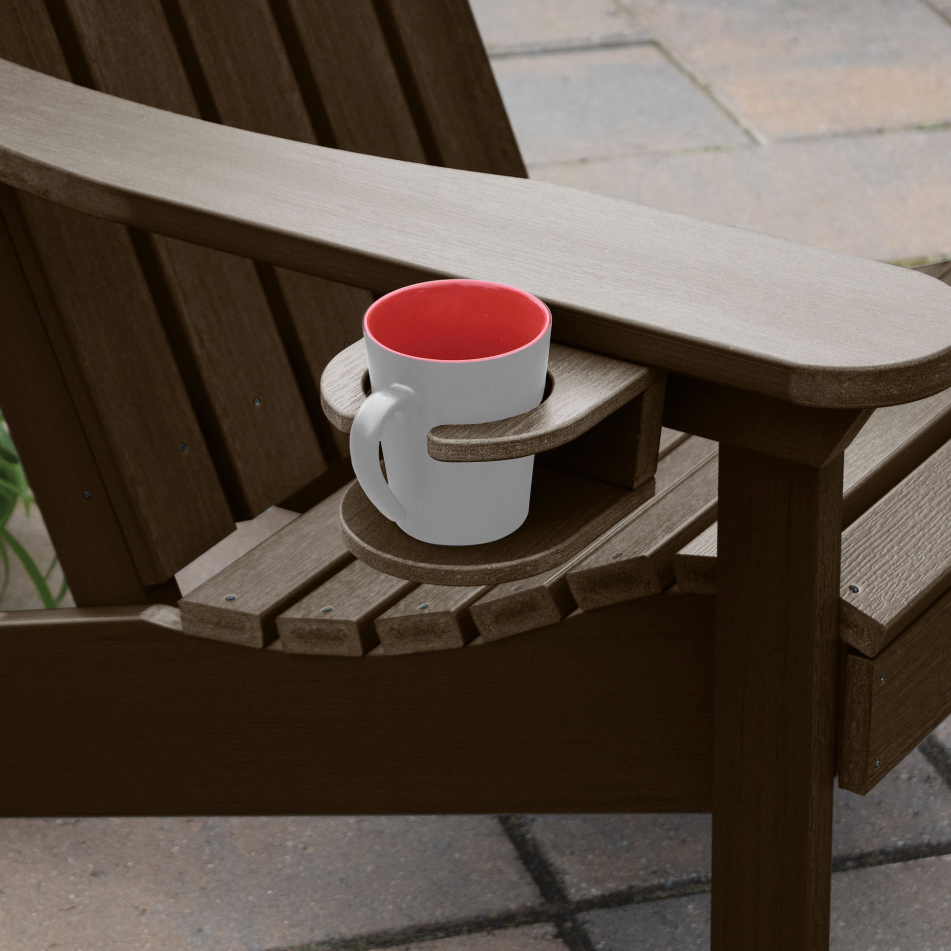 Brown Adirondack chair and cupholder with mug