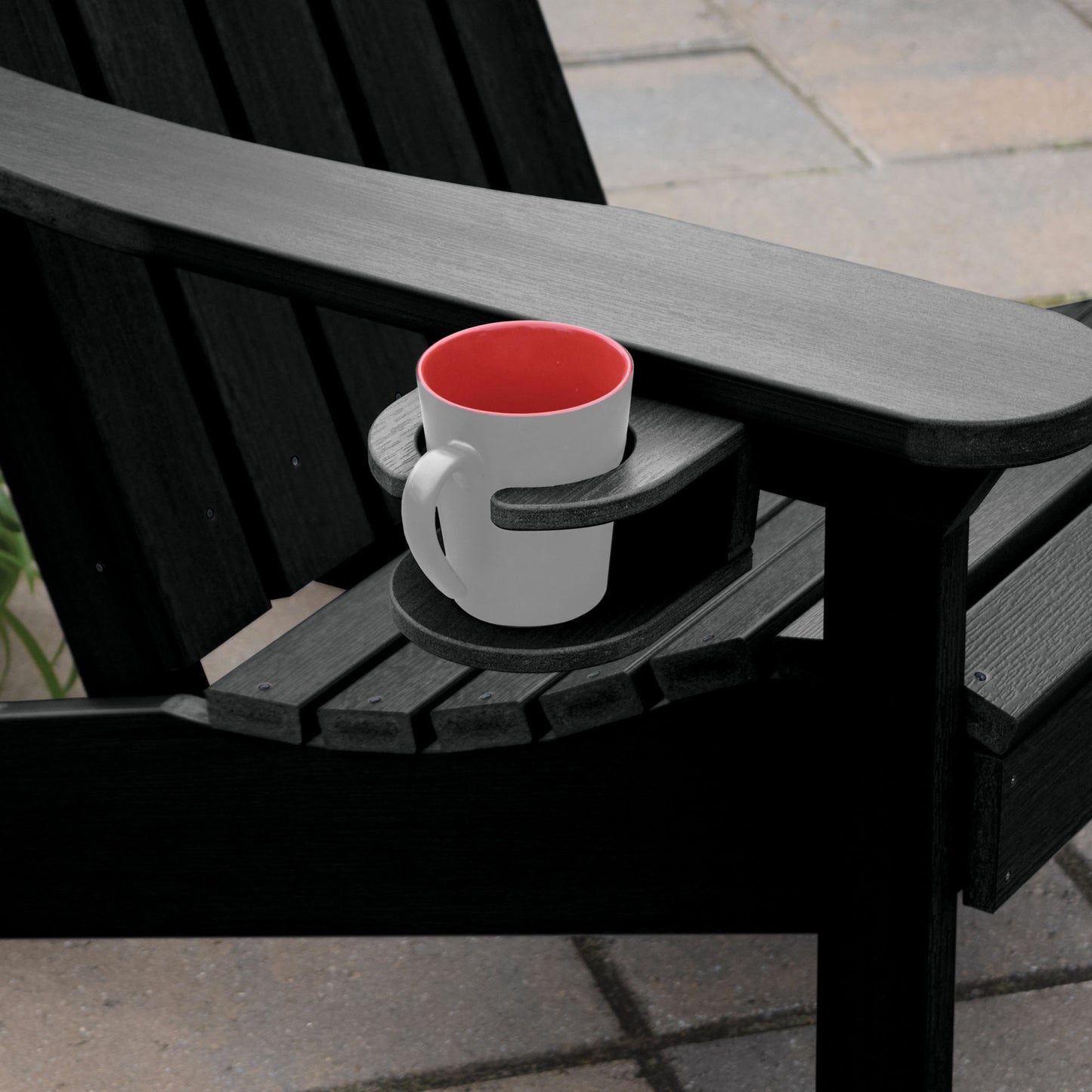 Black Adirondack chair and cupholder with mug