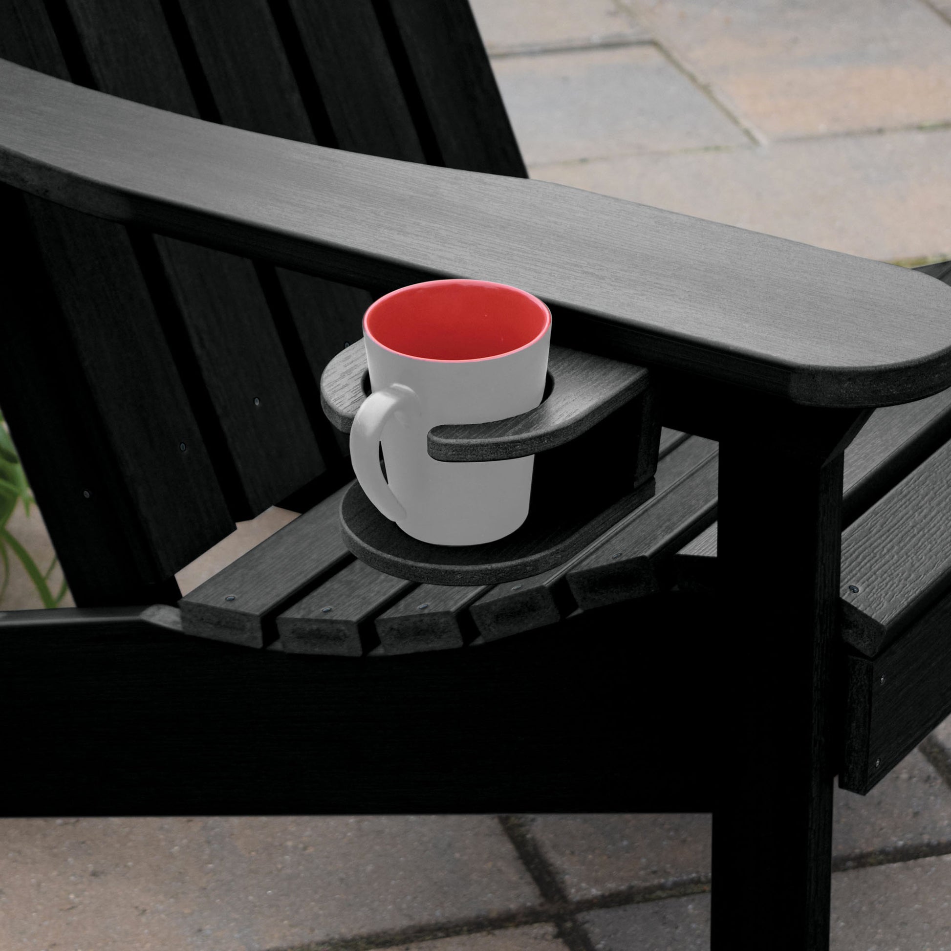 Black Adirondack chair and cupholder with mug