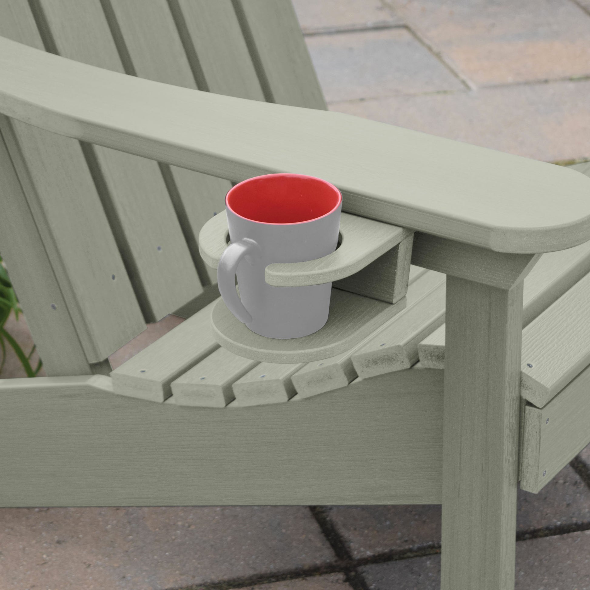 Light green Adirondack chair and cupholder with mug
