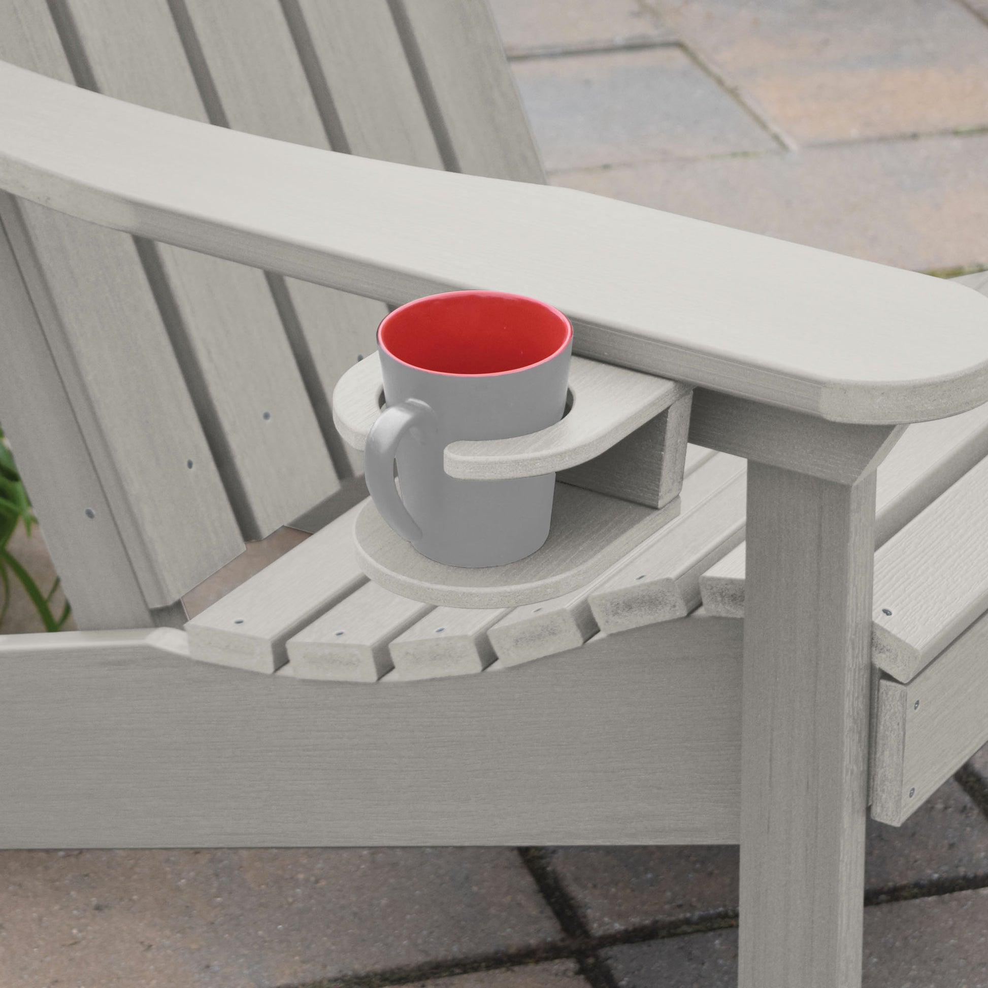 Light gray Adirondack chair and cupholder with mug