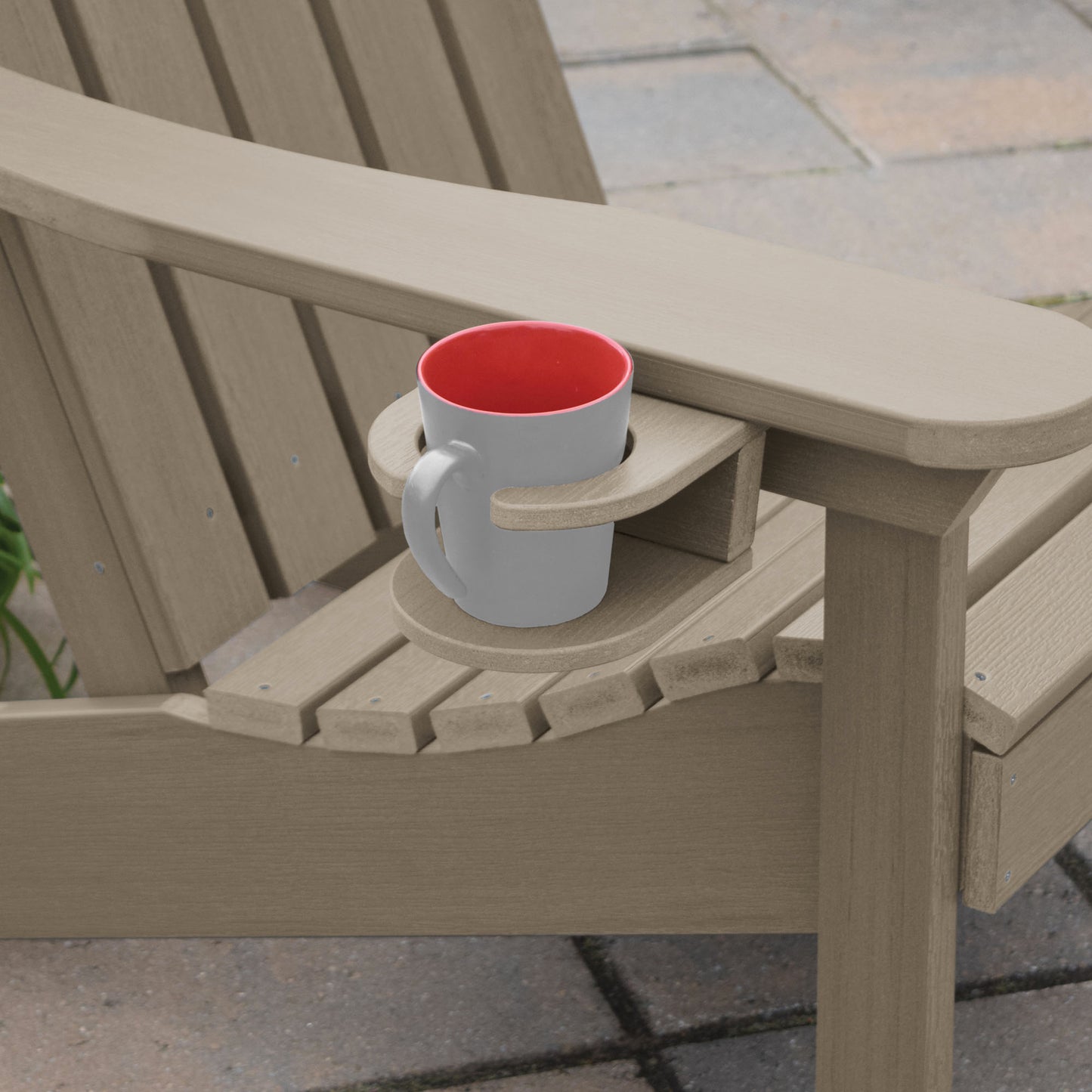 Light brown Adirondack chair and cupholder with mug