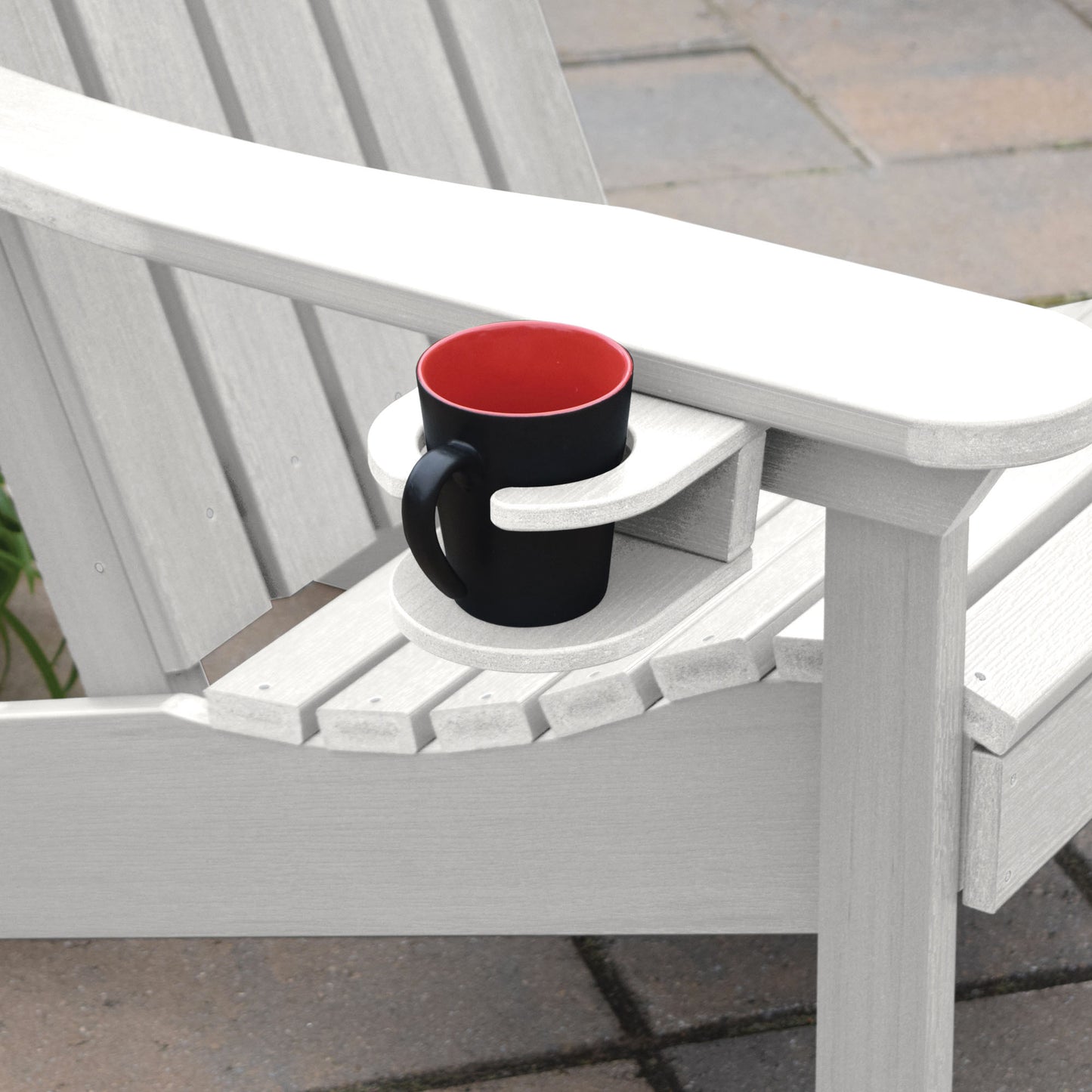 White Adirondack chair and cupholder with mug