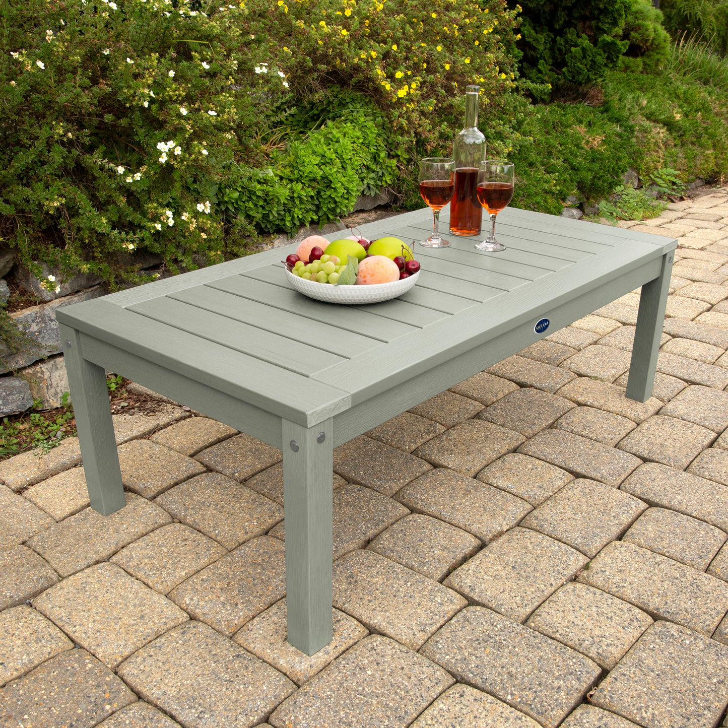 Light green Adirondack Conversation table with wine and fruit bowl