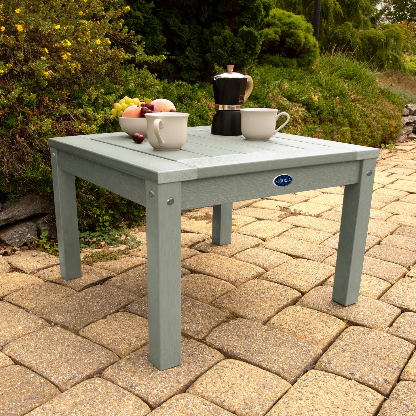 Light green Adirondack side table with coffee and fruit bowl