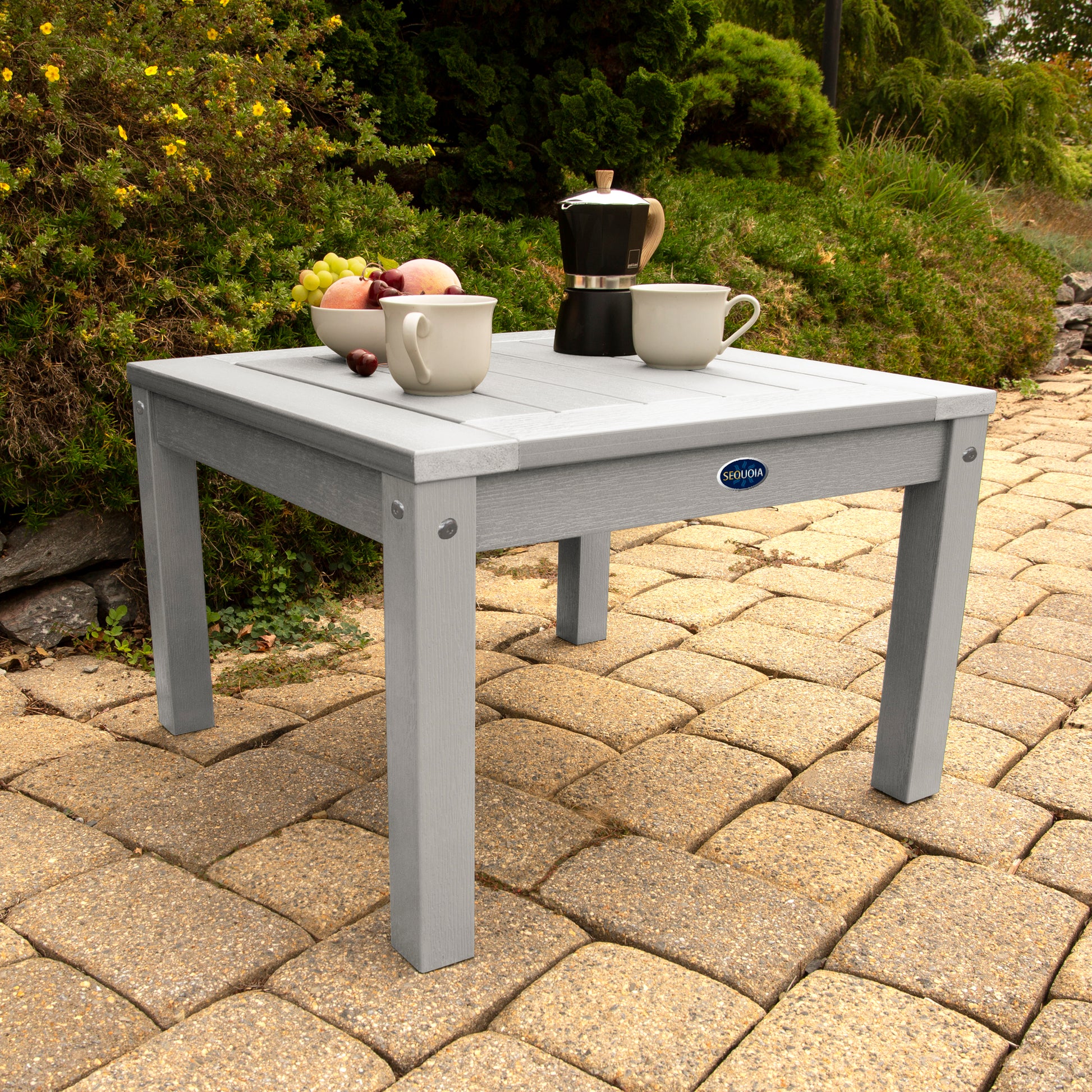 Light gray Adirondack side table with coffee and fruit bowl
