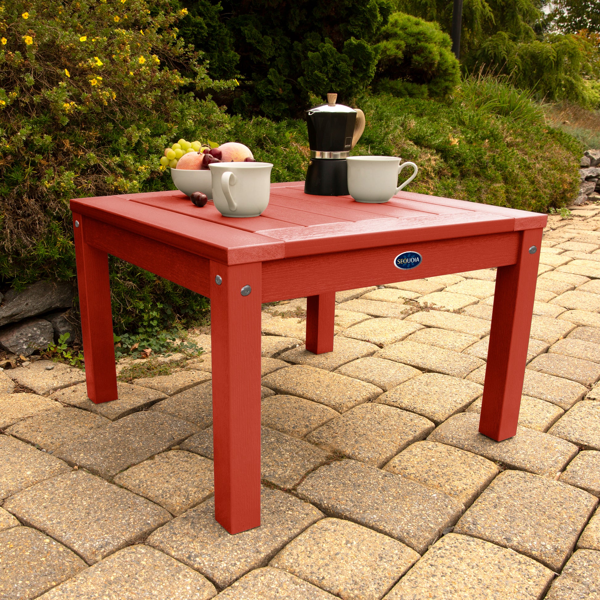 Red Adirondack side table with coffee and fruit bowl