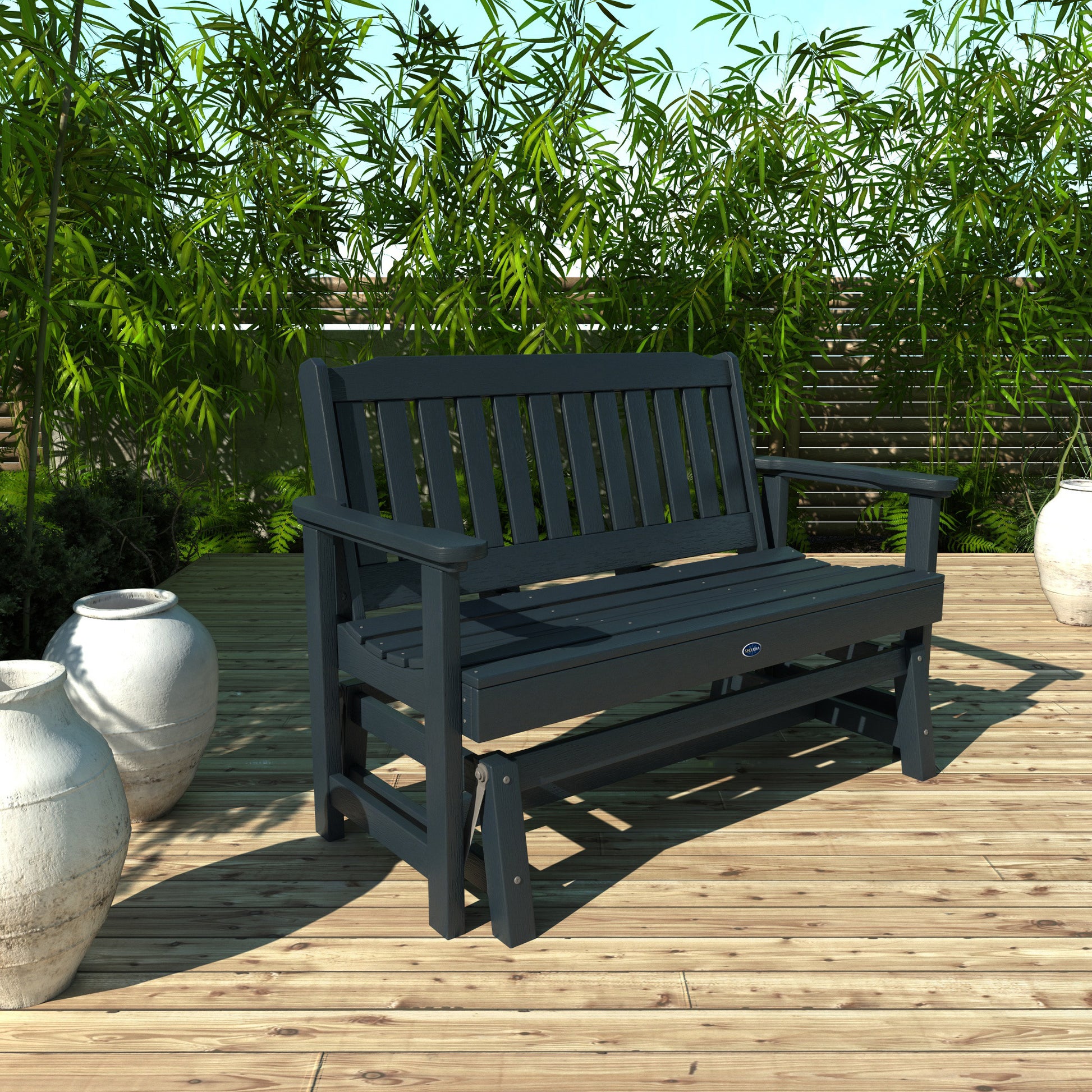 4ft dark blue Blue Ridge glider bench on wooden patio with plants in background