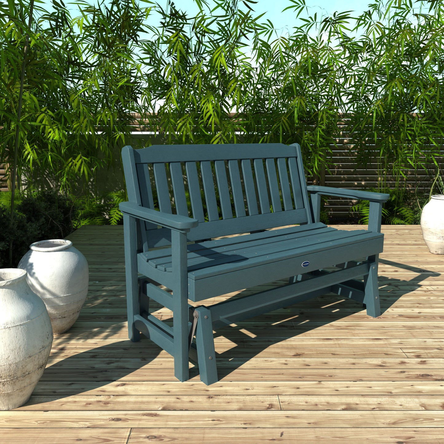 4ft light blue Blue Ridge glider bench on wooden patio with plants in background