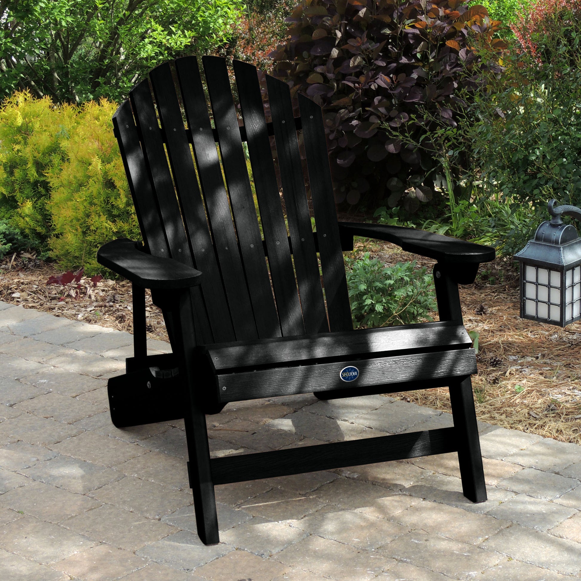 Black Horizon Adirondack chair on stone with trees in background