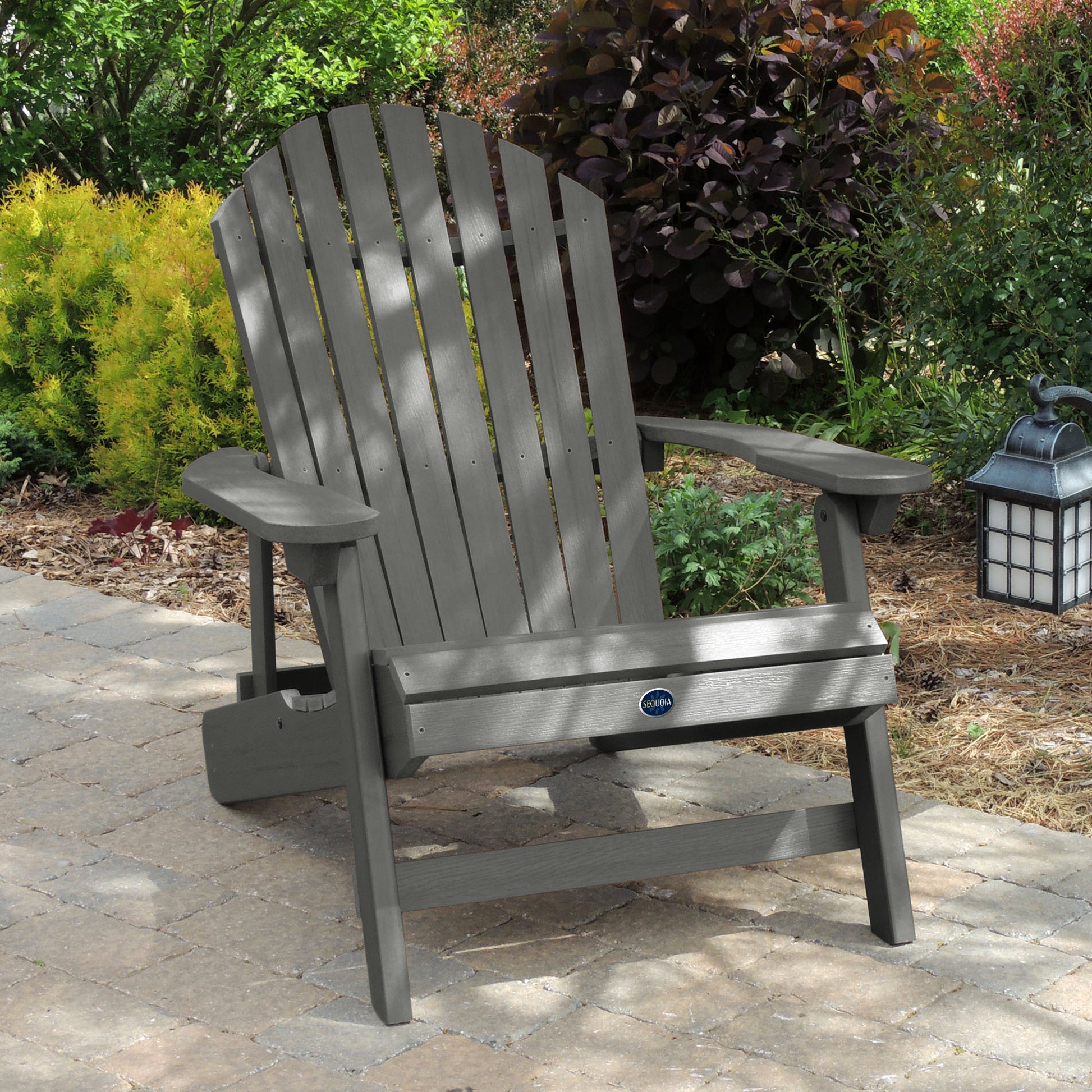 Gray Horizon Adirondack chair on stone with trees in background