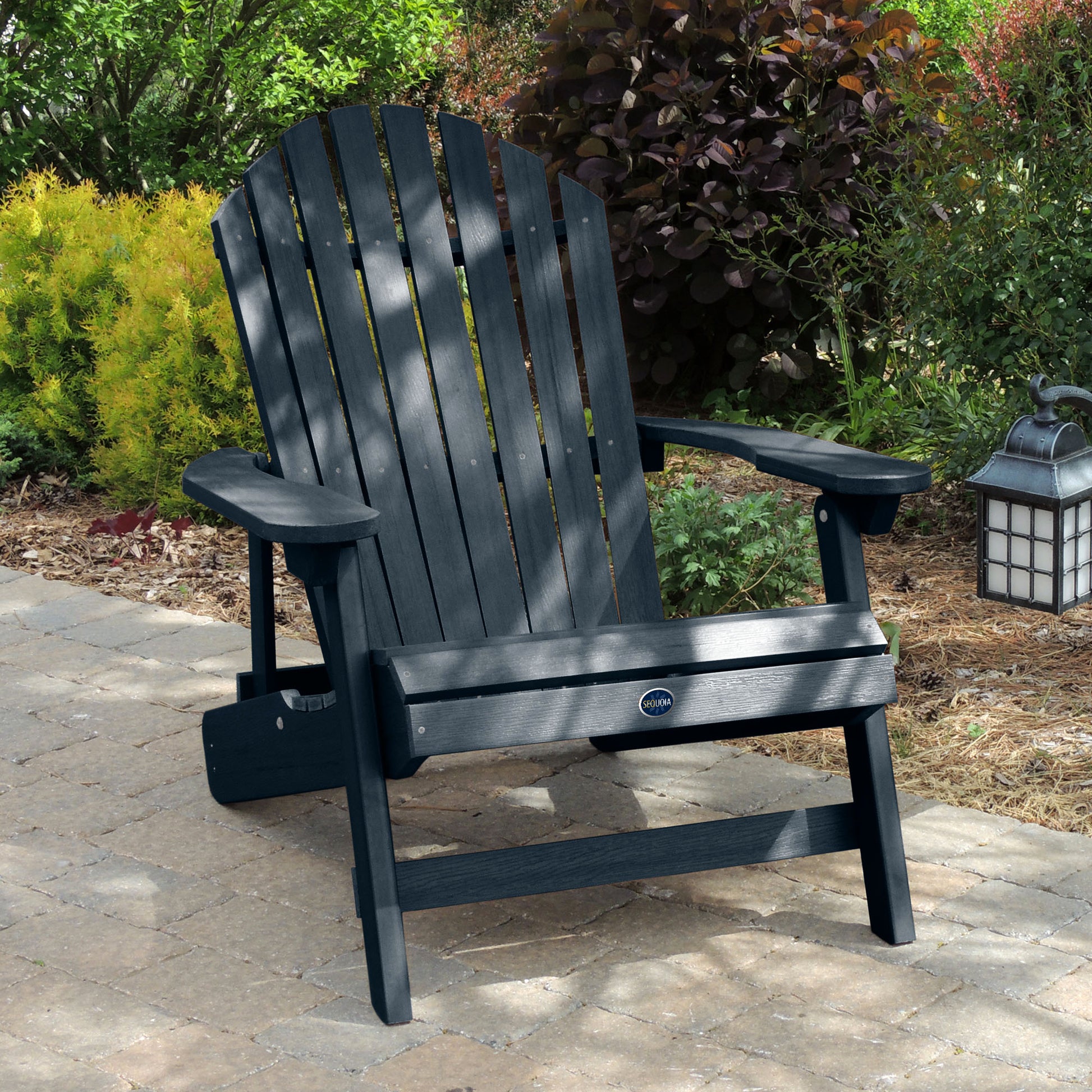 Dark Blue Horizon Adirondack chair on stone with trees in background