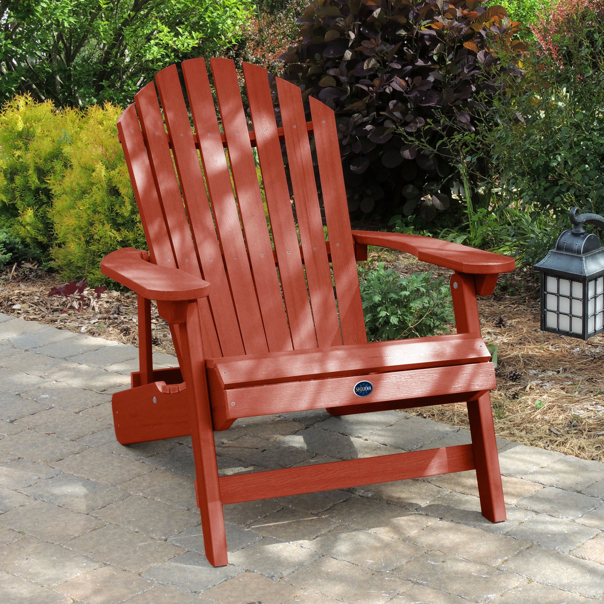 Red Horizon Adirondack chair on stone with trees in background