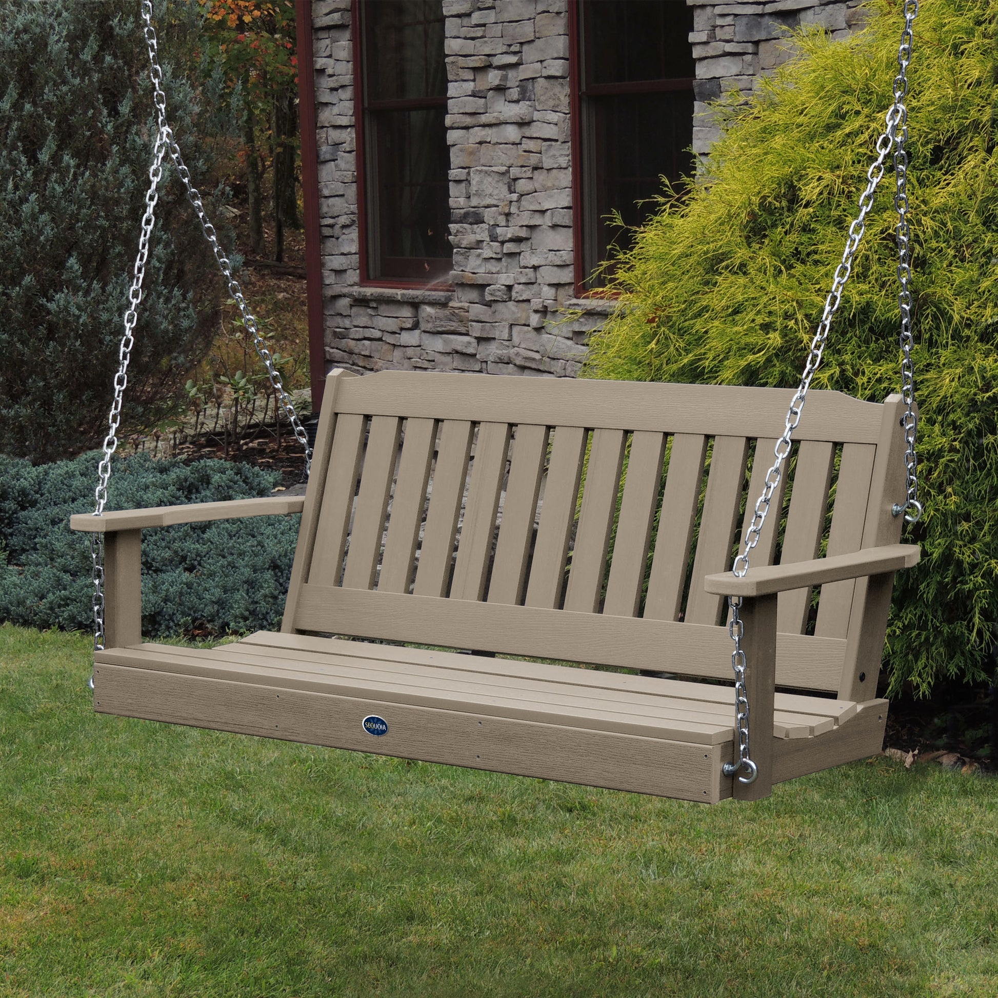 Light brown 5ft Blue Ridge porch swing with stone house in background