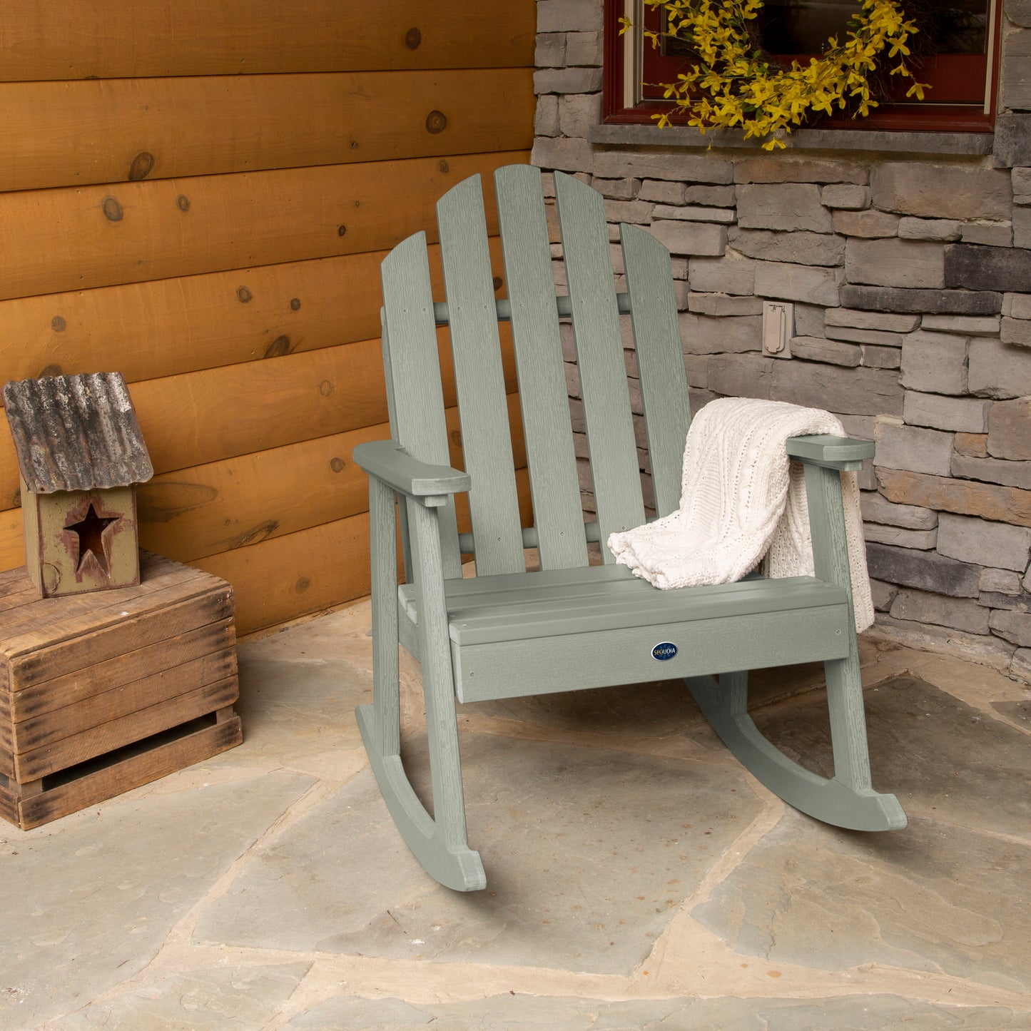 Light green Lighthouse Garden Rocking Chair on porch with blanket