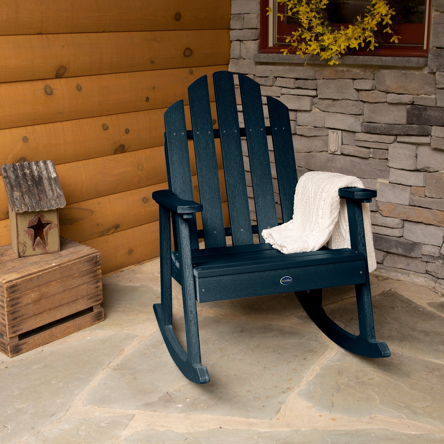Dark blue Lighthouse Garden Rocking Chair on porch with blanket