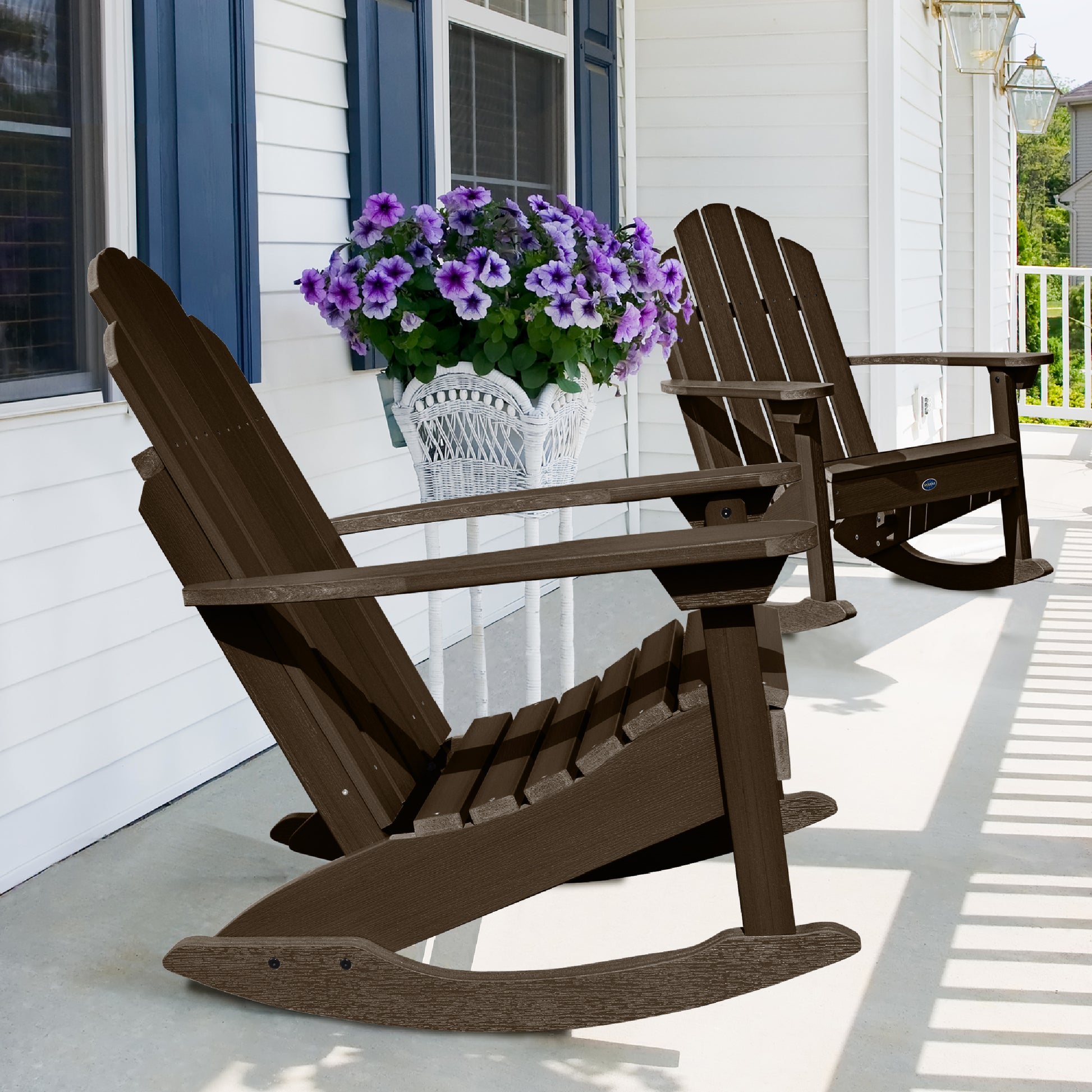Two Brown Lighthouse Adirondack rocking chairs on front porch with flowers