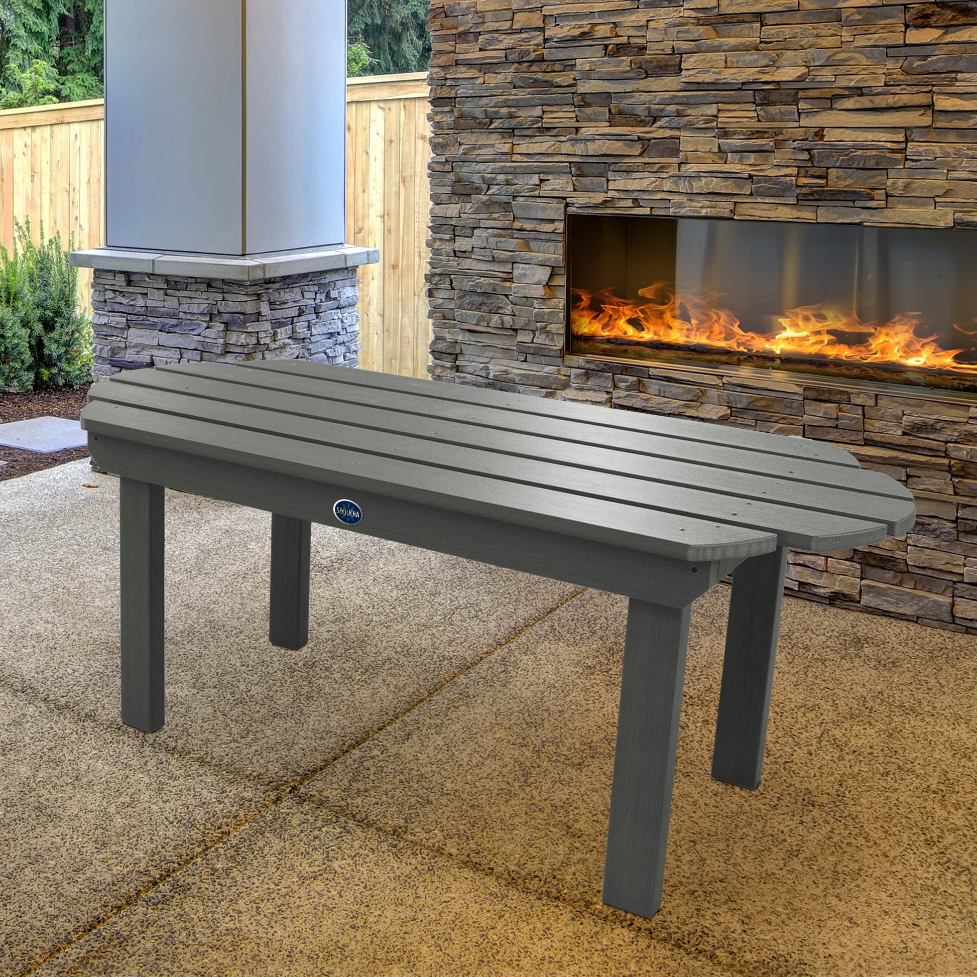 Gray Lighthouse conversation table in front of outdoor fireplace