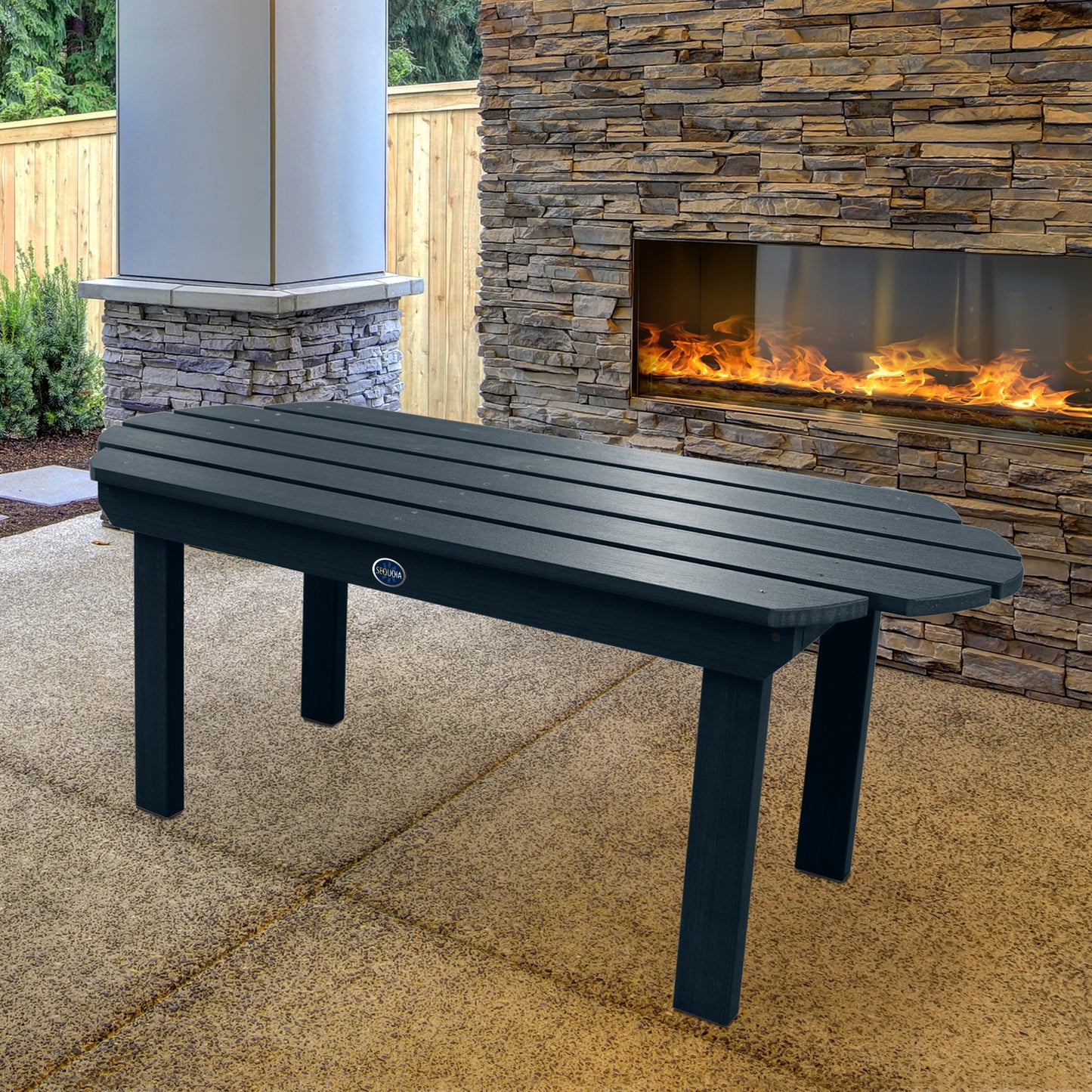 Dark blue Lighthouse conversation table in front of outdoor fireplace