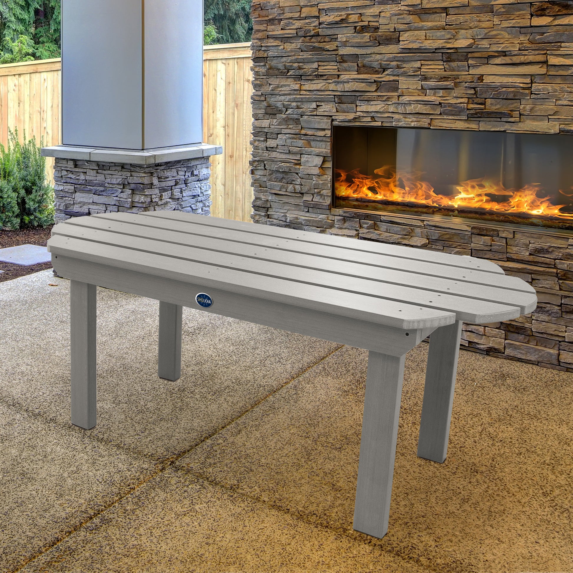 Light gray Lighthouse conversation table in front of outdoor fireplace