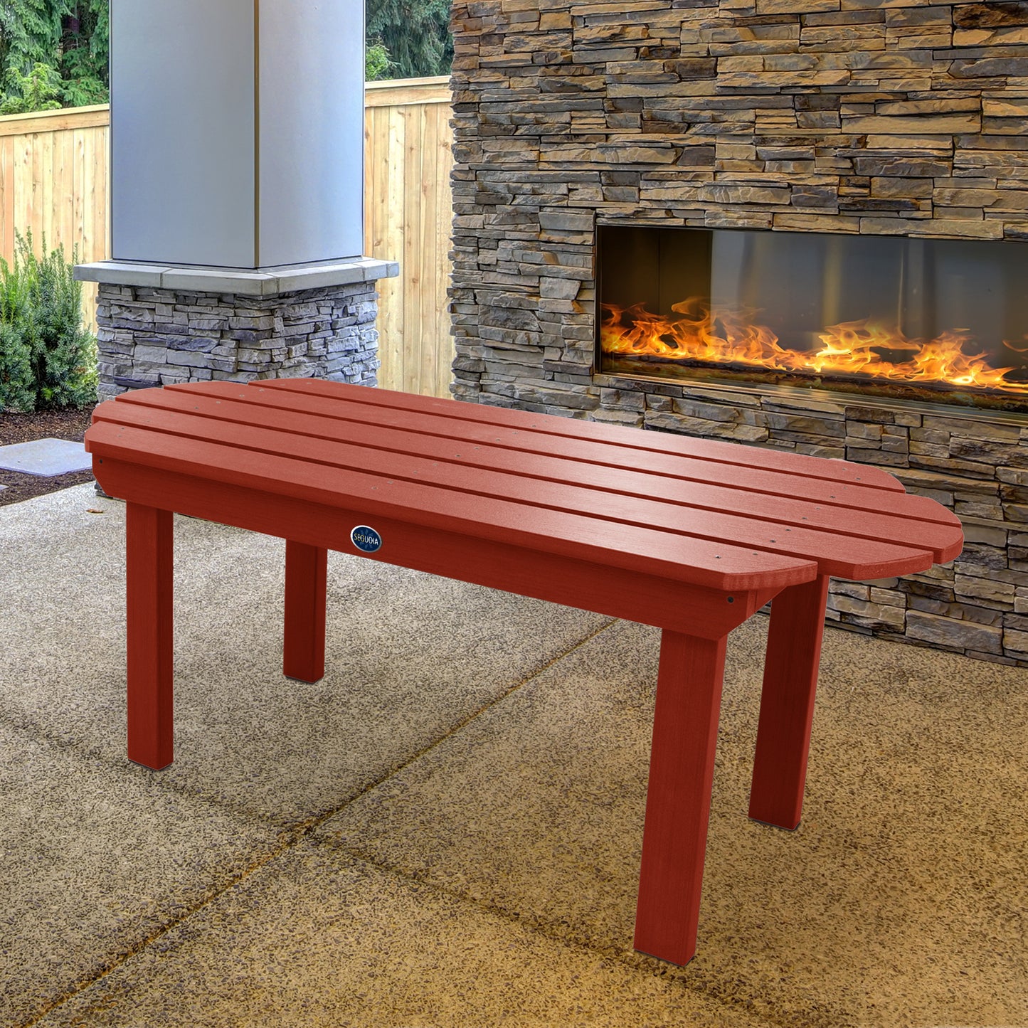 Red Lighthouse conversation table in front of outdoor fireplace