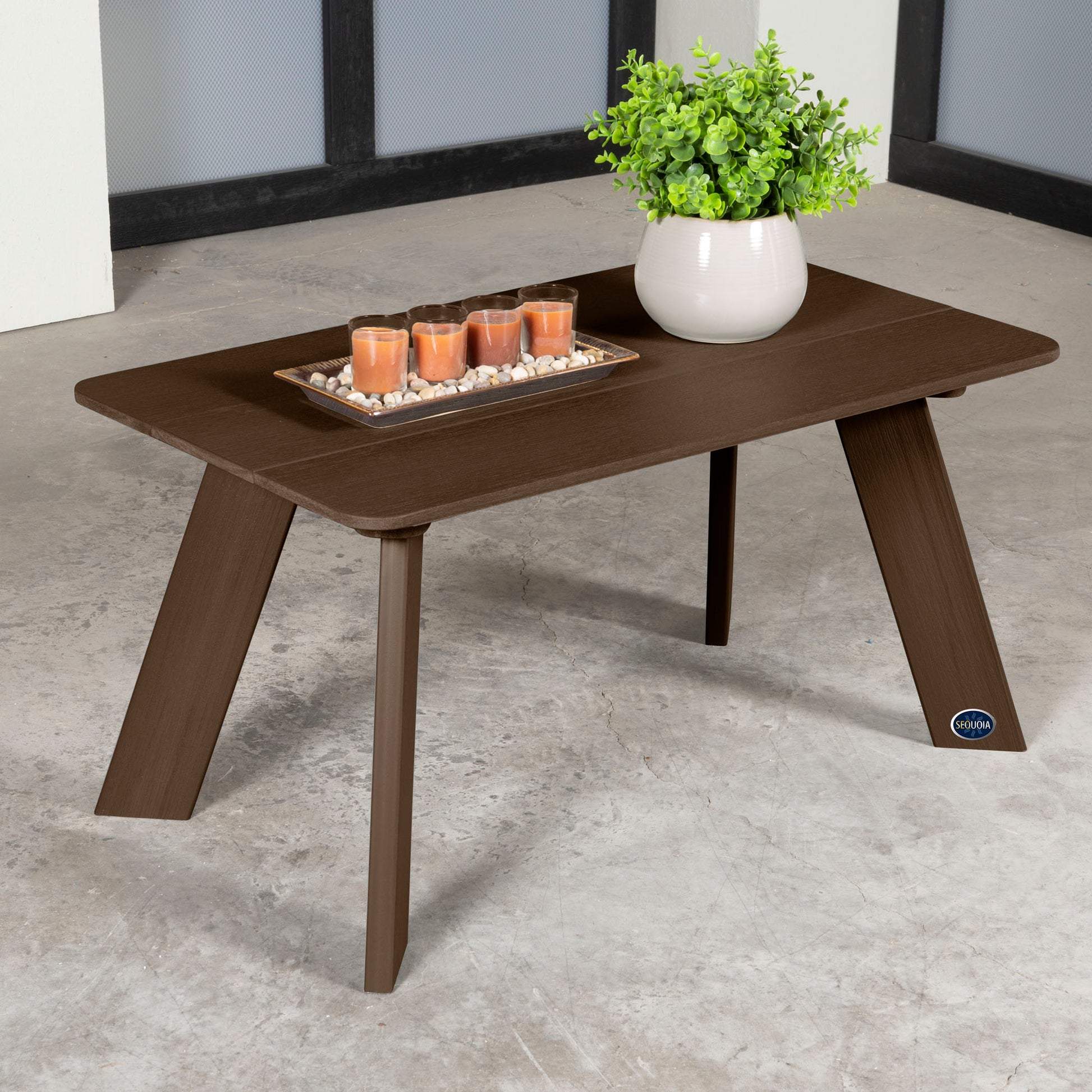 Brown Granite Hills coffee table with candles and plant