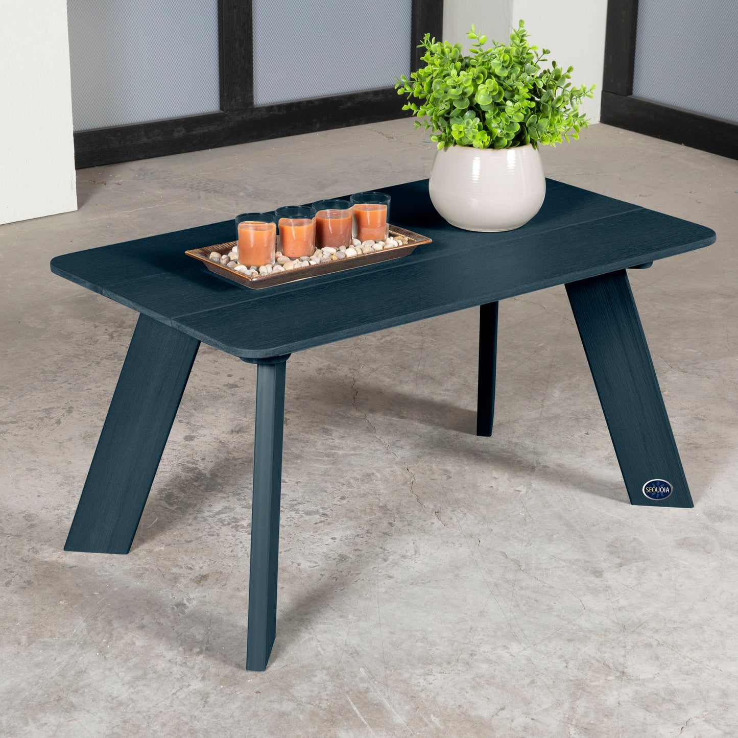 Dark blue Granite Hills coffee table with candles and plant