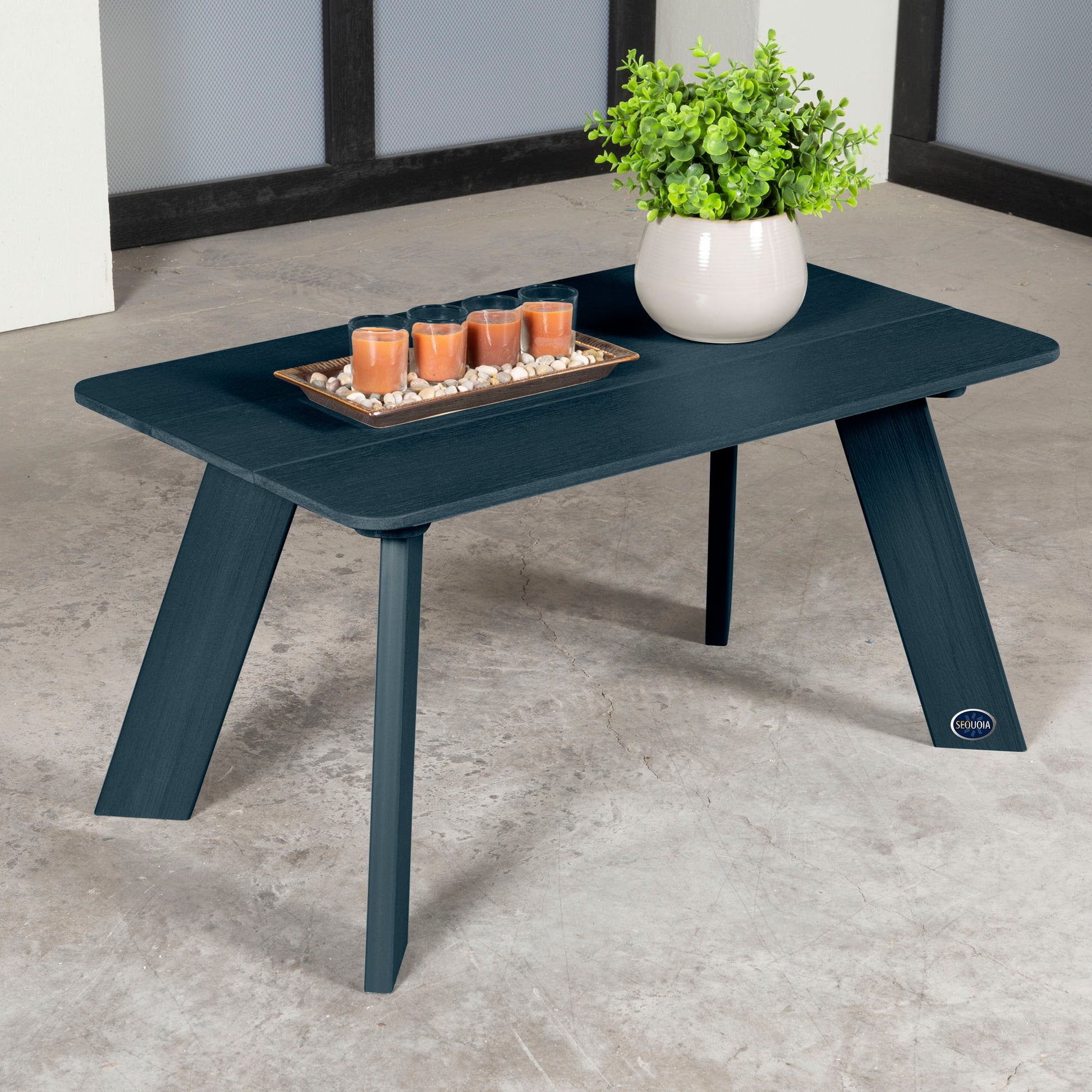 Dark blue Granite Hills coffee table with candles and plant