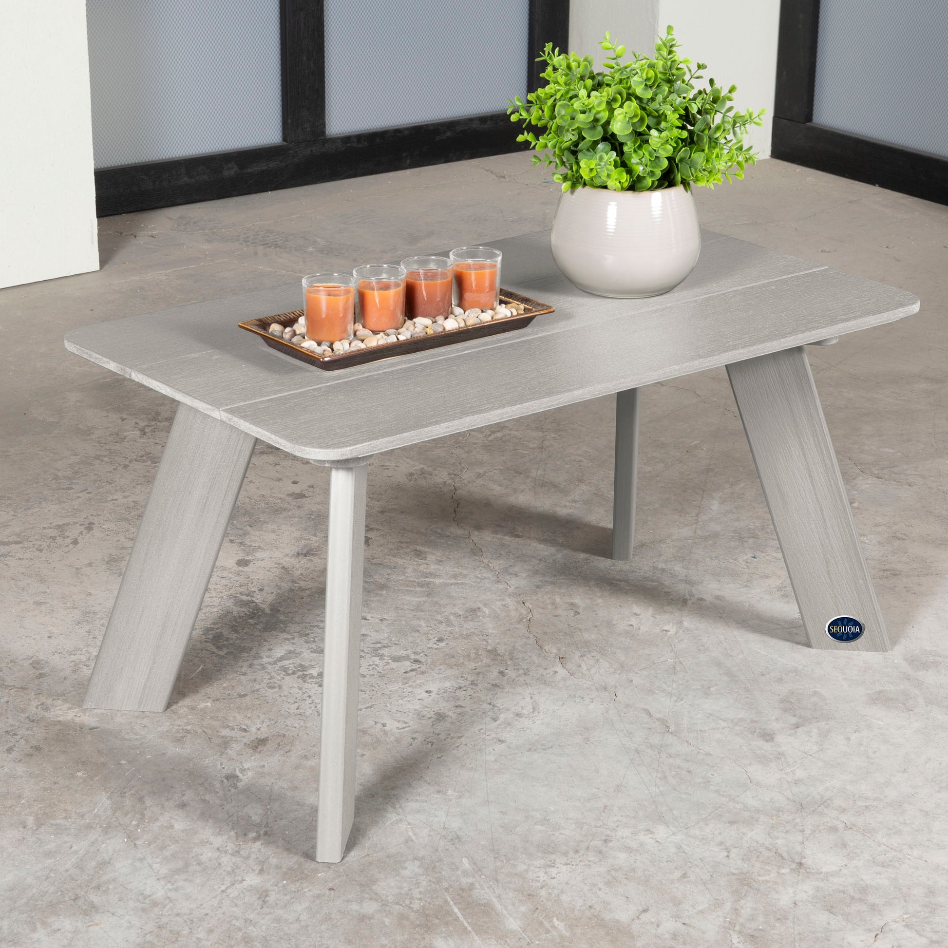 Light gray Granite Hills coffee table with candles and plant