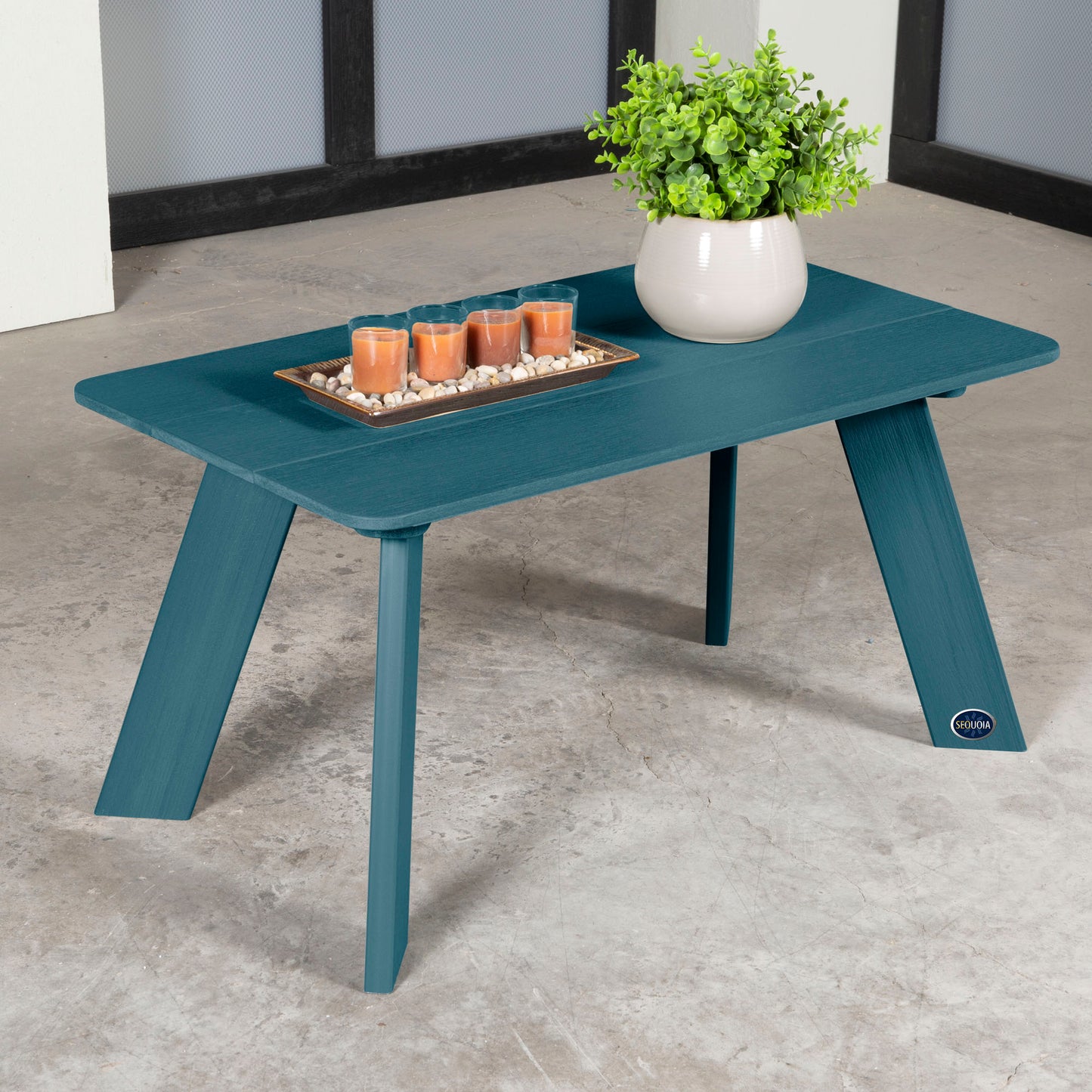 Blue Granite Hills coffee table with candles and plant