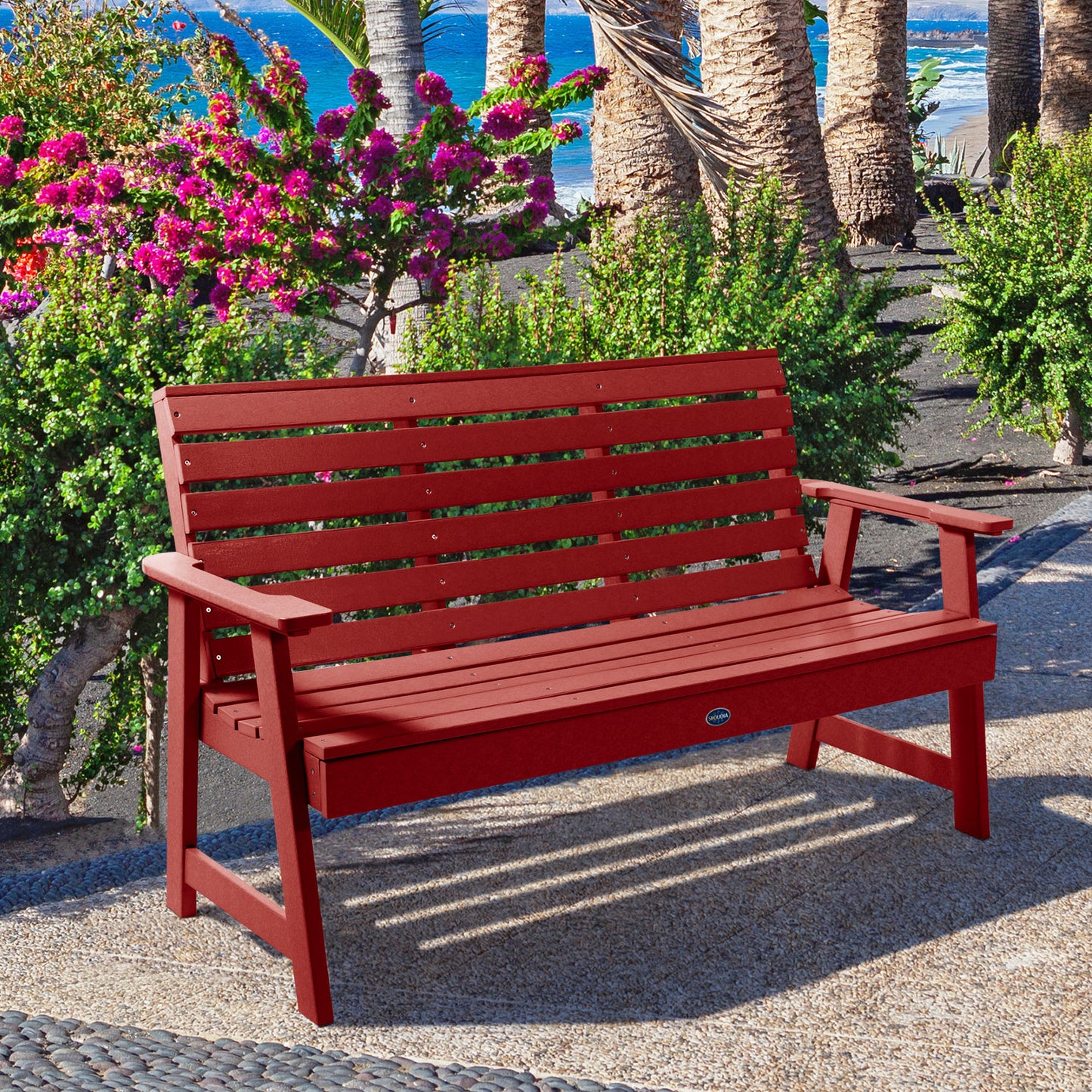Red Sunrise Coast 5ft bench in front of flowers on walkway
