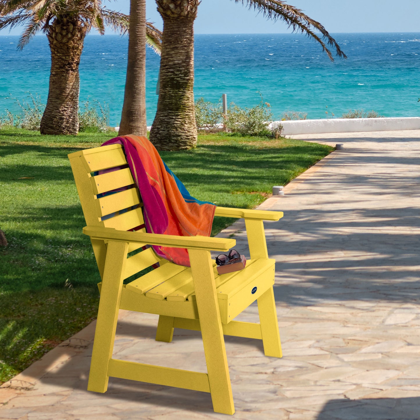 Yellow Sunrise Coast garden chair on walkway near water